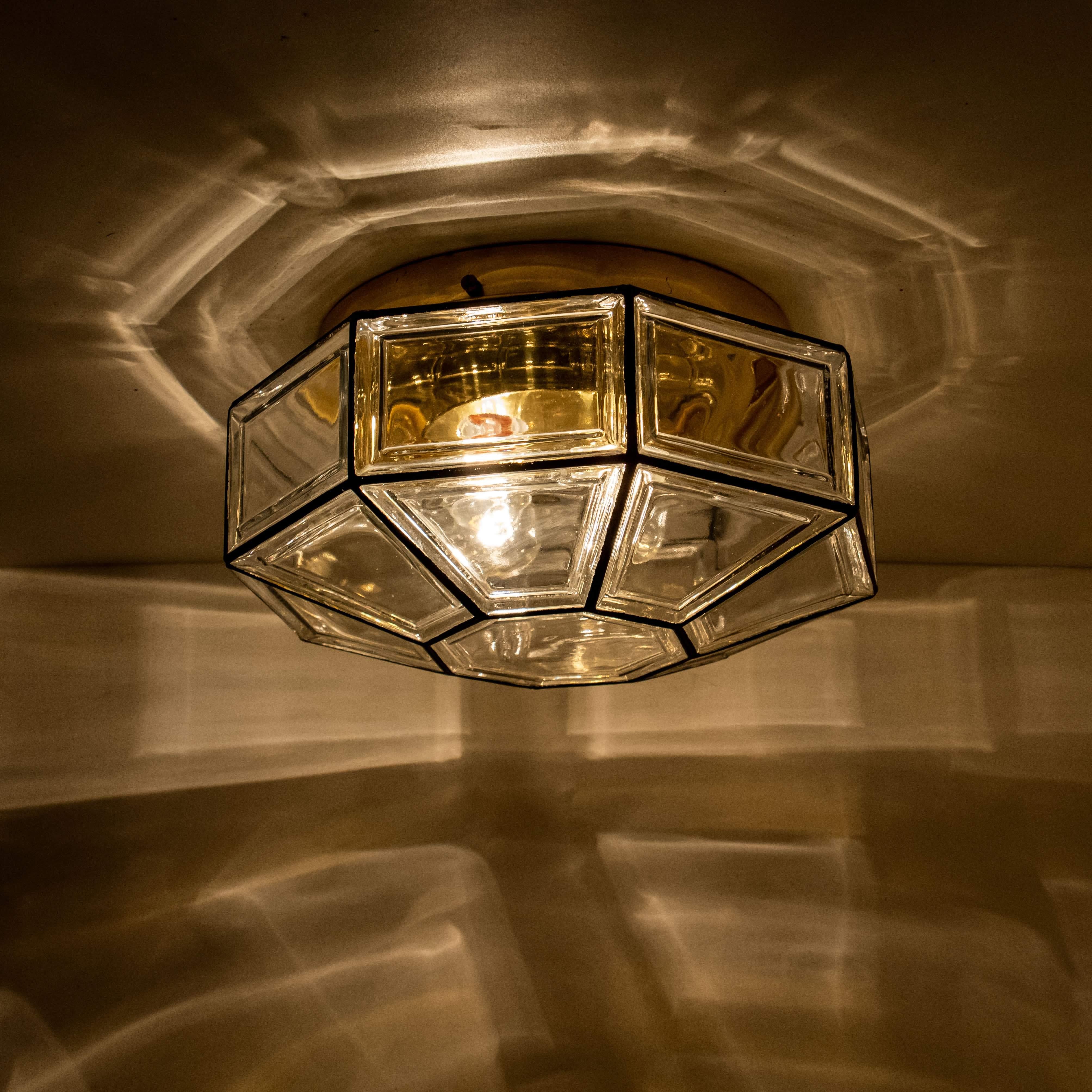 This beautiful and unique octagonal glass light flushmount or wall light was manufactured by Glashütte Limburg in Germany during the 1960s, (late 1960s or early 1970s). Nice craftsmanship. Elaborate clear bubble glass which bulges slightly out of