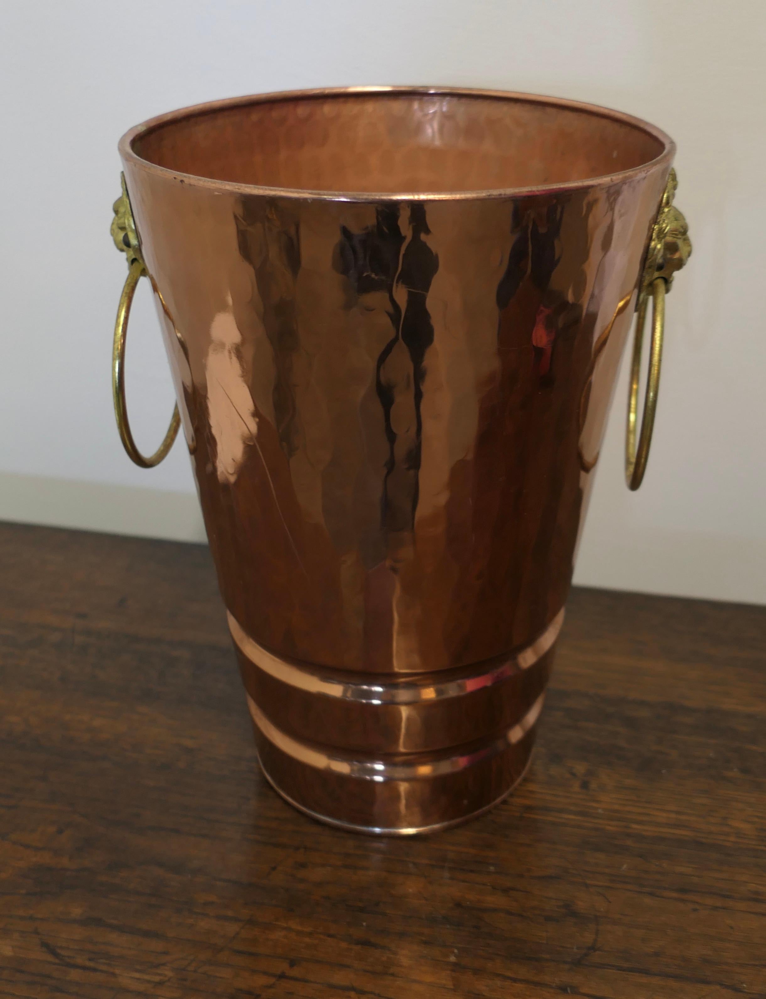 Extra large copper and brass Villedieu champagne/ice bucket 

This is a lovely looking Vintage Villedieu Champagne/Ice Bucket Made from Copper and Brass, Made in France
The bucket has a rolled top edge and the ring handles are set with lions