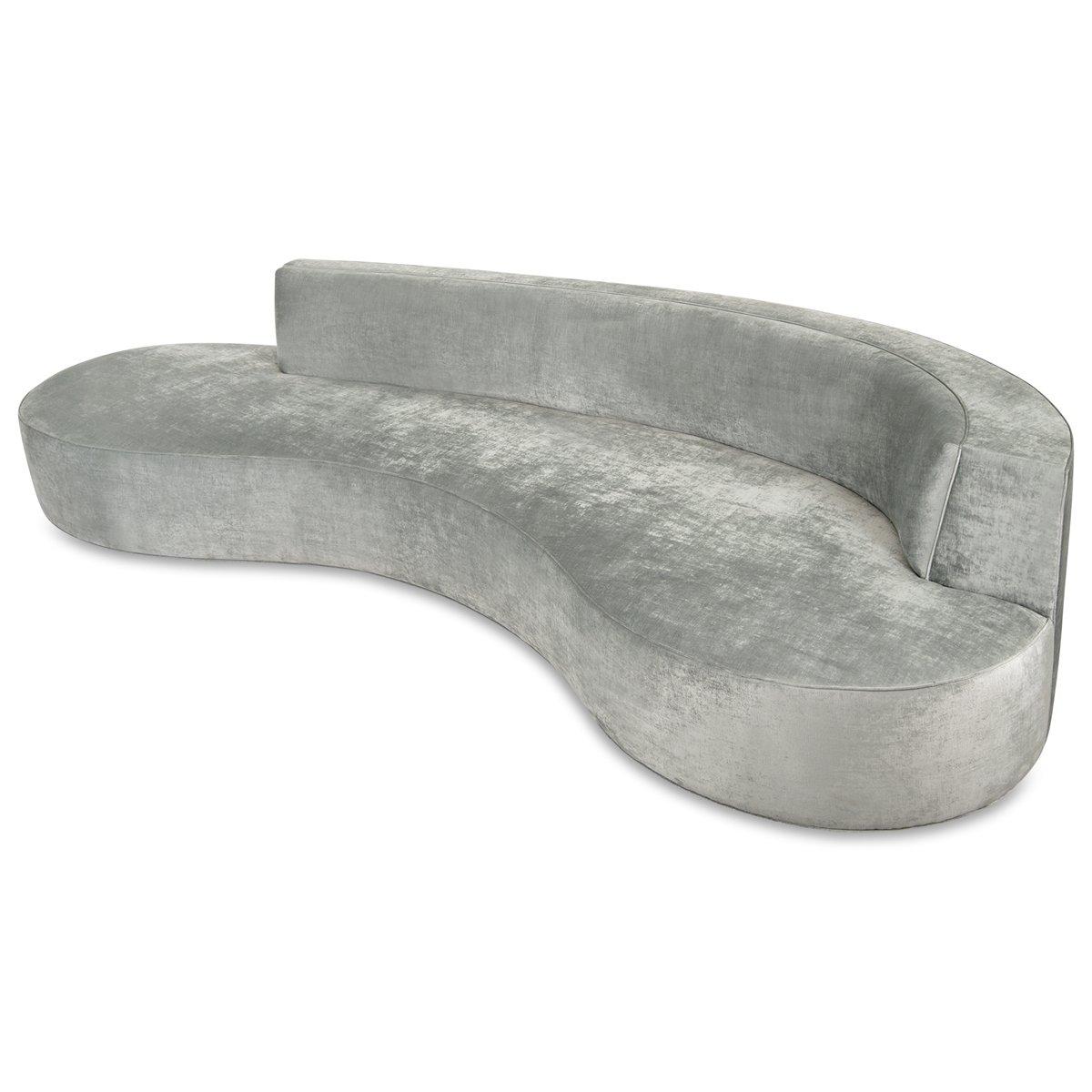 Sleep and clean lines define this extra large chaise sofa. With a kidney bean shape, it is upholstered in a lustrous silver velvet and is sure to stand out in any large space.