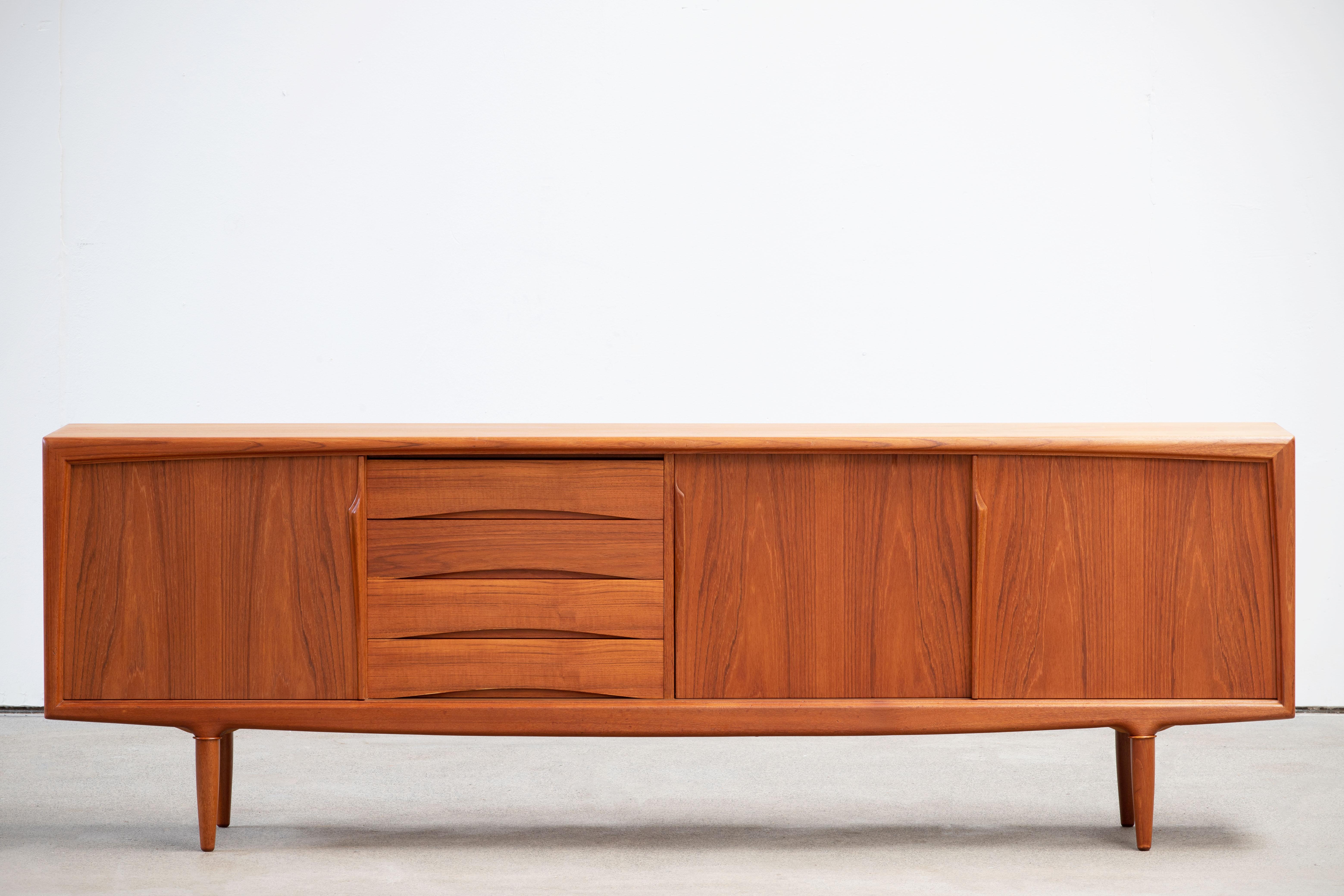 Stunning midcentury designed by Gunni Omann teak sideboard by ACO Møbler, 1960s, lovely top and sliding doors, fully lined (four) drawers and stands on nice solid teak legs (this is the very scarce model that has the round legs without the