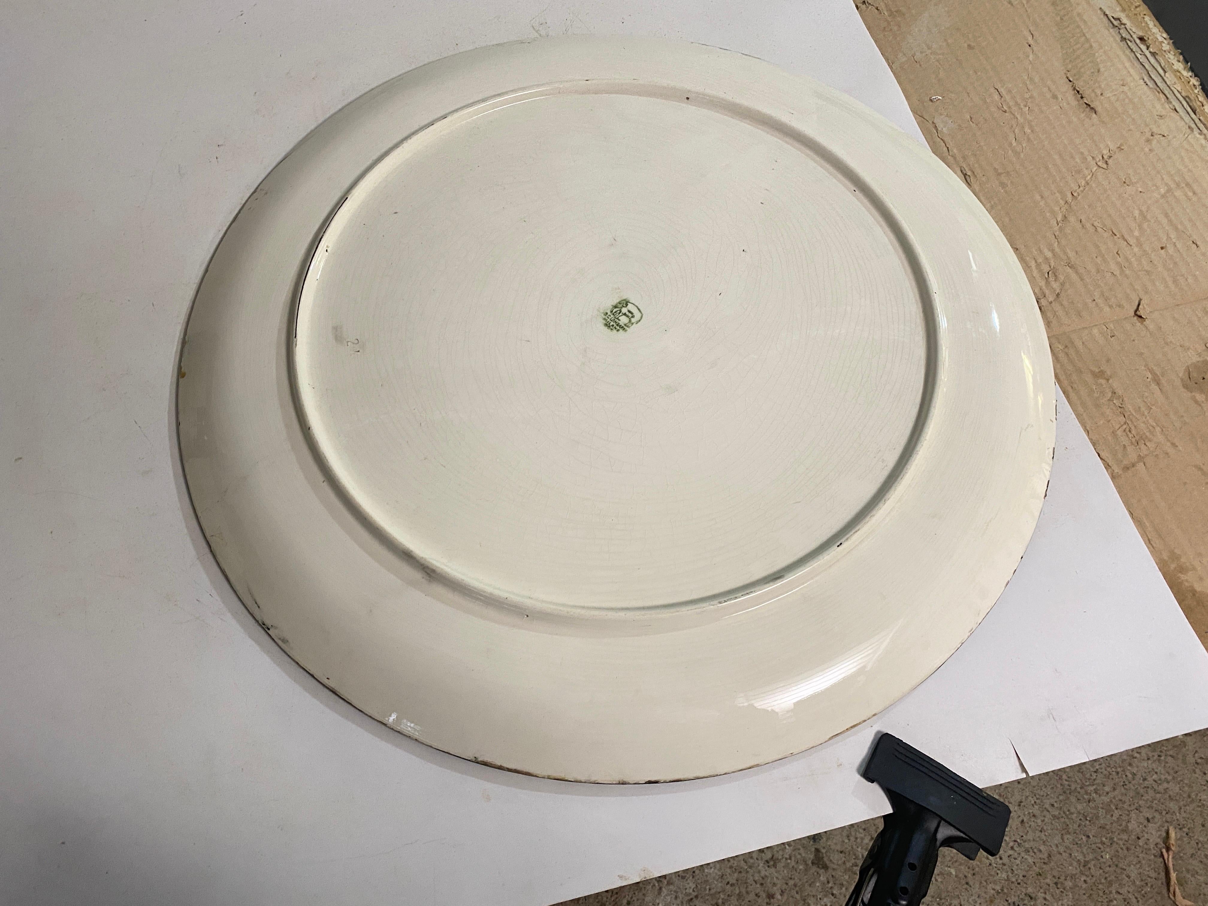 Extra Large Ceramic dish in Yellow and Dark blue color. This is a dish that was made in the 20th Century  in Italy It is very Heavy heavy, in good condition Representing a soldier. Signed C.Lombardo Milano.
