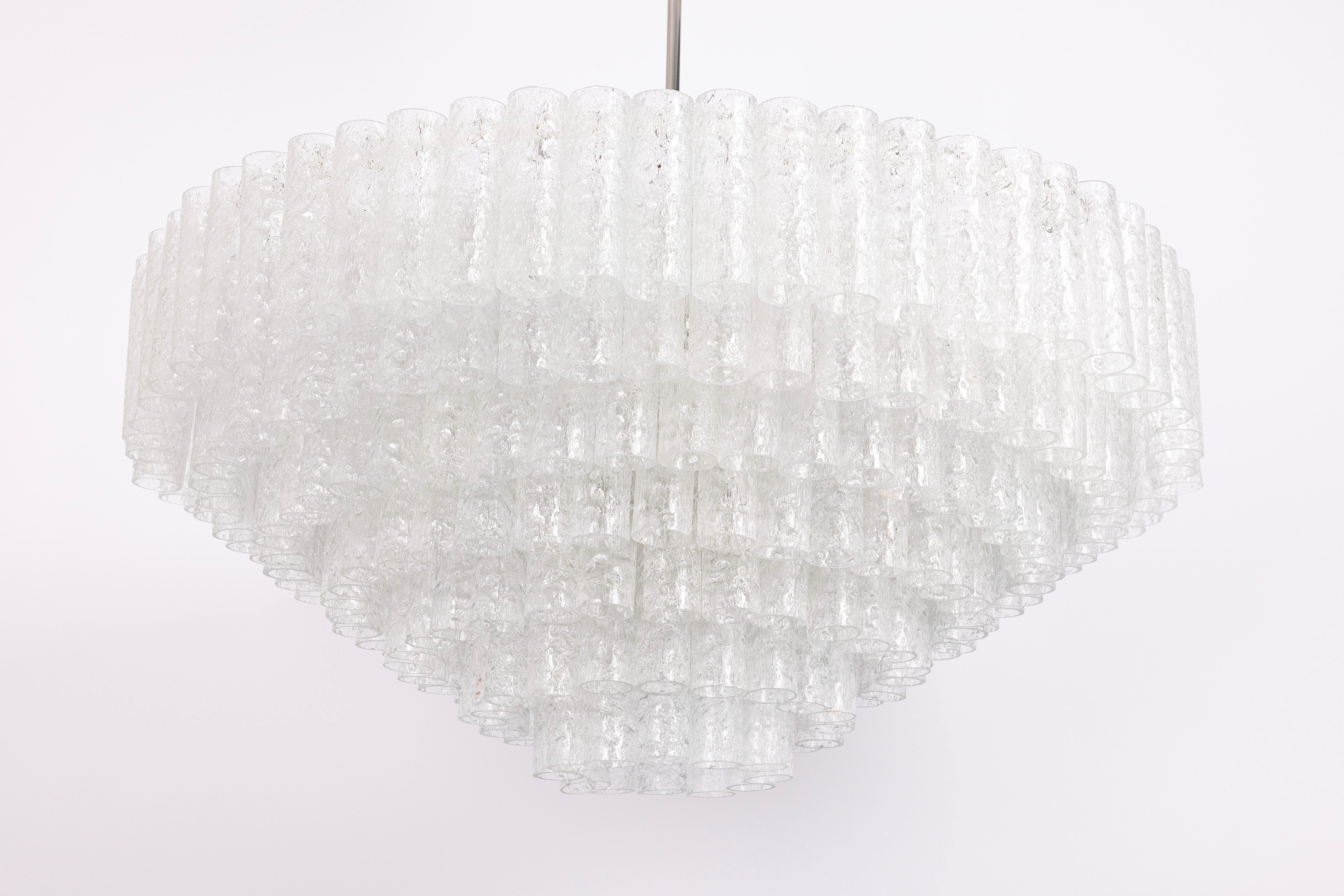 Fantastic Seven-tier midcentury chandelier by Doria, Germany, manufactured circa 1960-1969. 6 rings of Murano glass cylinders suspended from a fixture.

Sockets: 35x E14 candelabra bulbs (up to 40 W each) .
Light bulbs are not included. It is