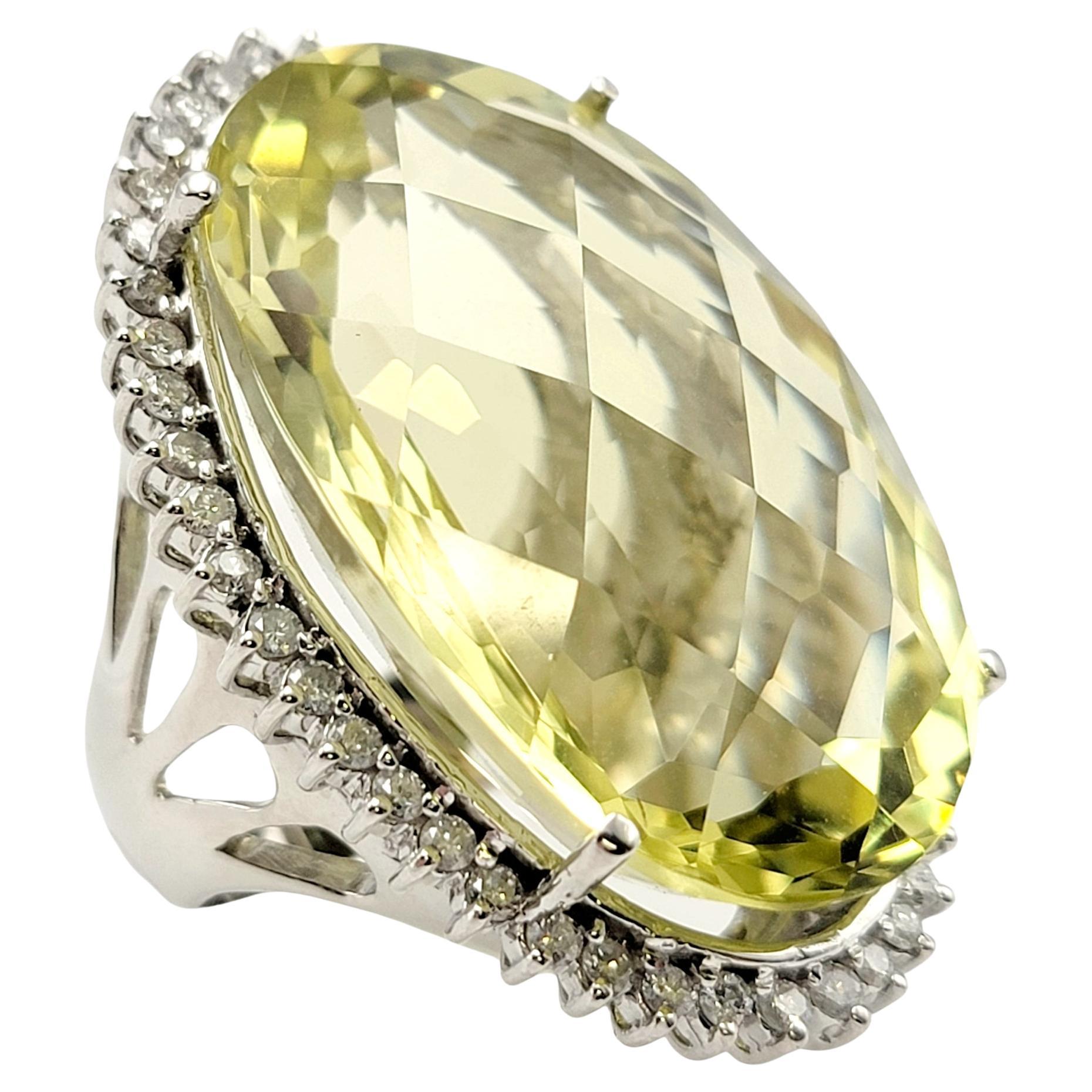 Ring size: 6

Huge, show-stopping cocktail ring absolutely lights up the finger. The stunning oversize lemon citrine quartz stone sparkles spectacularly with its bright, crystal clear greenish-yellow color. The halo of icy white diamonds frames this