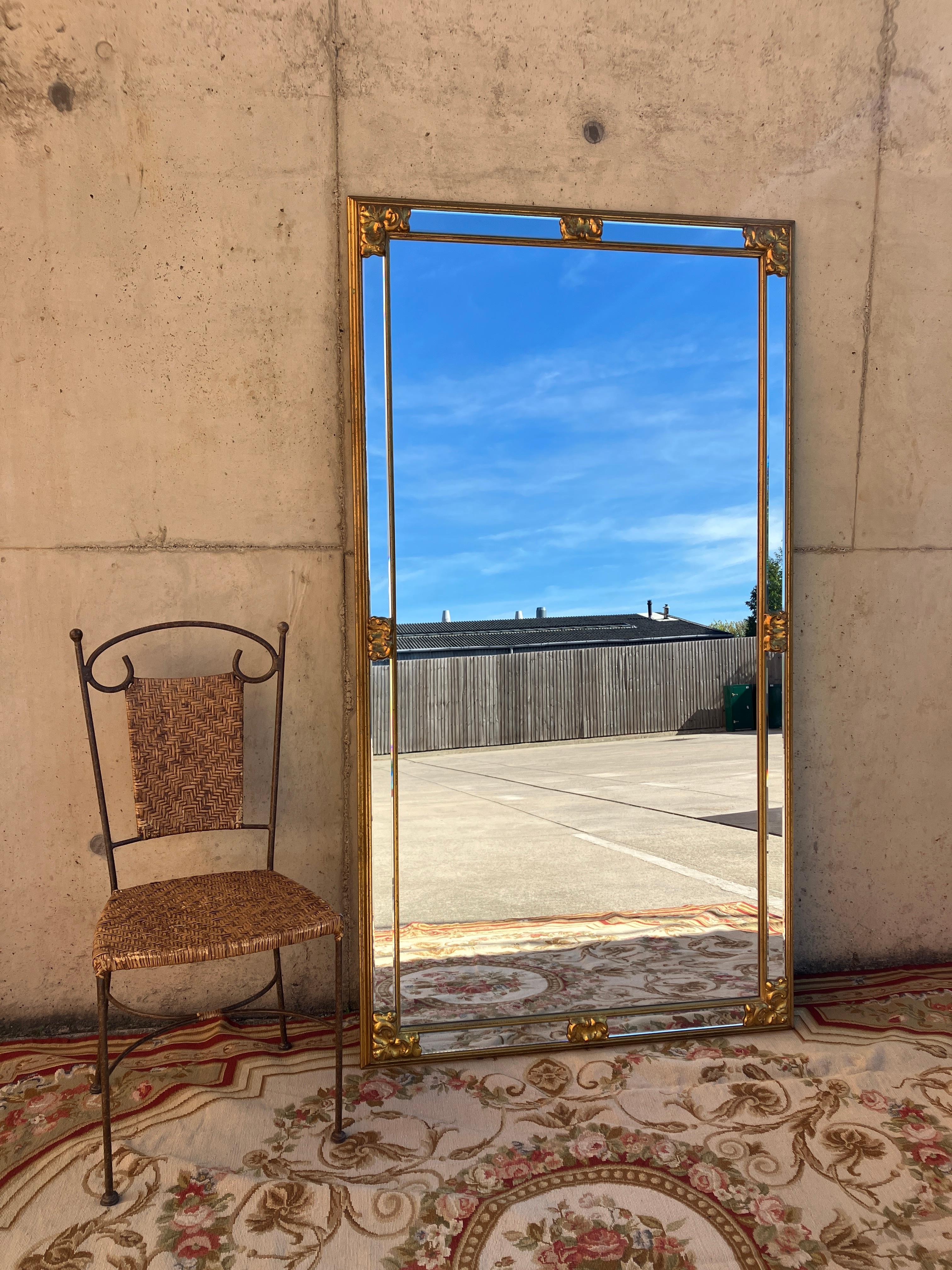 An extra large vintage mirror with a golden frame. The mirror can be hung on the wall above a large fireplace or it can be floor-standing. A gorgeous vintage mirror.

