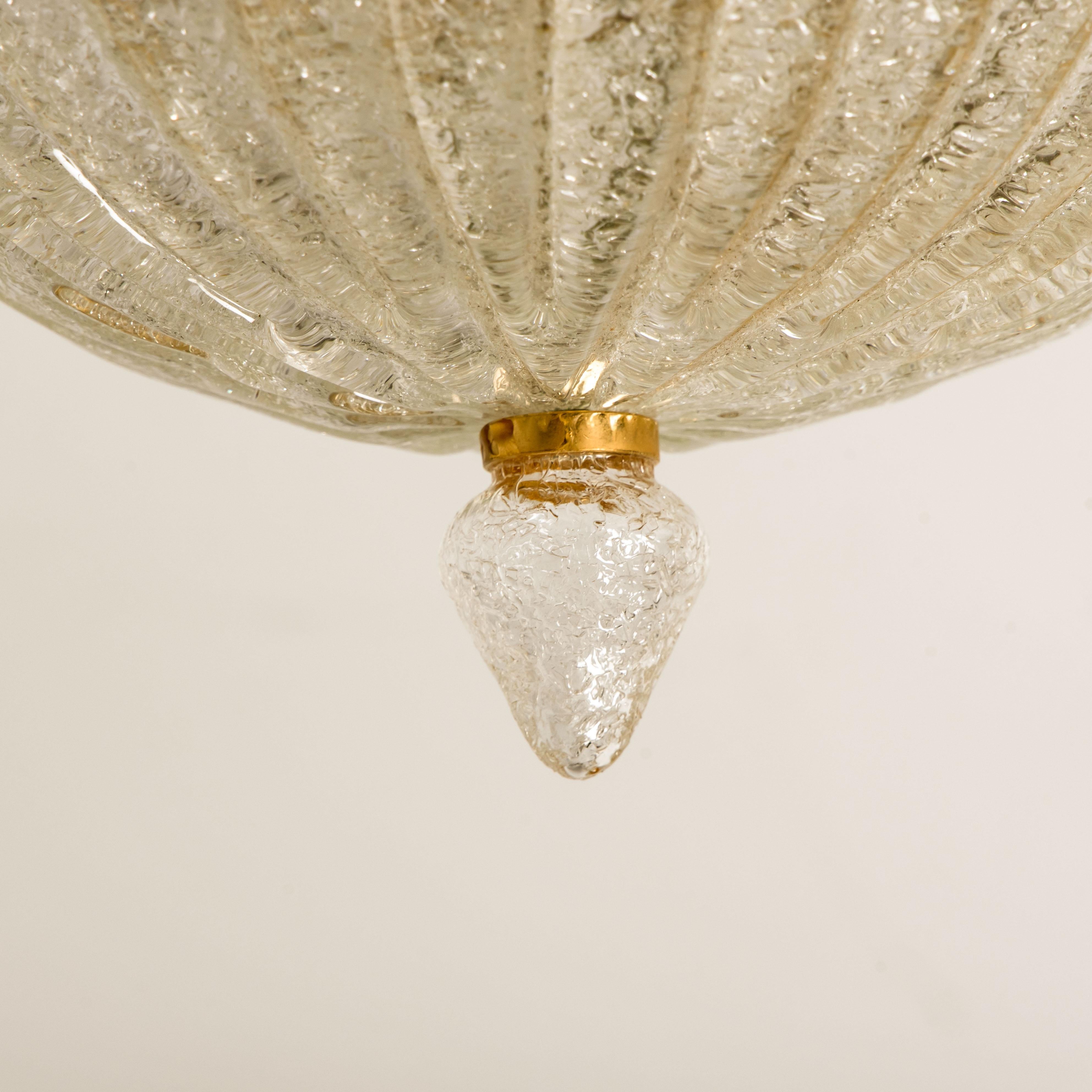An elegant hand blown Murano glass flushmount of Barovier & Toso. The light fixture consists 16 blown Murano glass leaves. Mounted on a brass frame. The leaves refract light beautifully. The flush mount fills the room with a soft, warm and welcoming