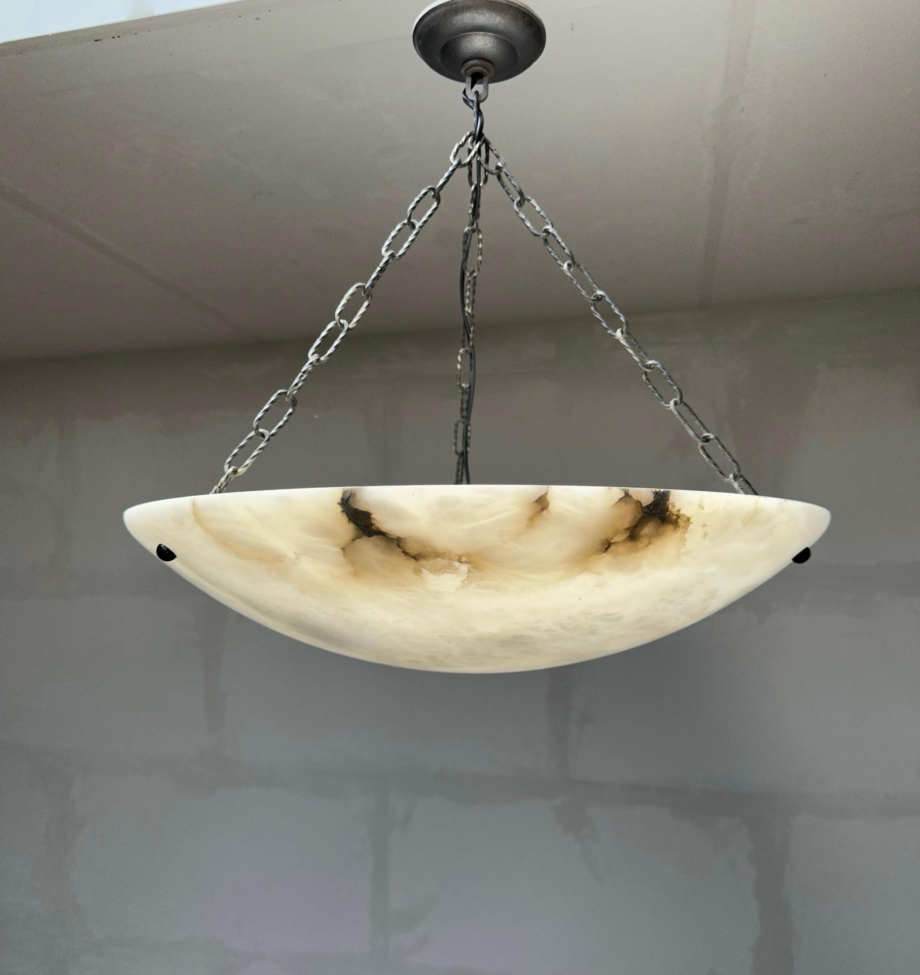 One of the largest and most stylish pure white alabaster pendant lights.

This rare, extra large size alabaster light fixture also is of a beautiful design. The beautiful and perfectly polished surface of this alabaster shade comes with a moon like