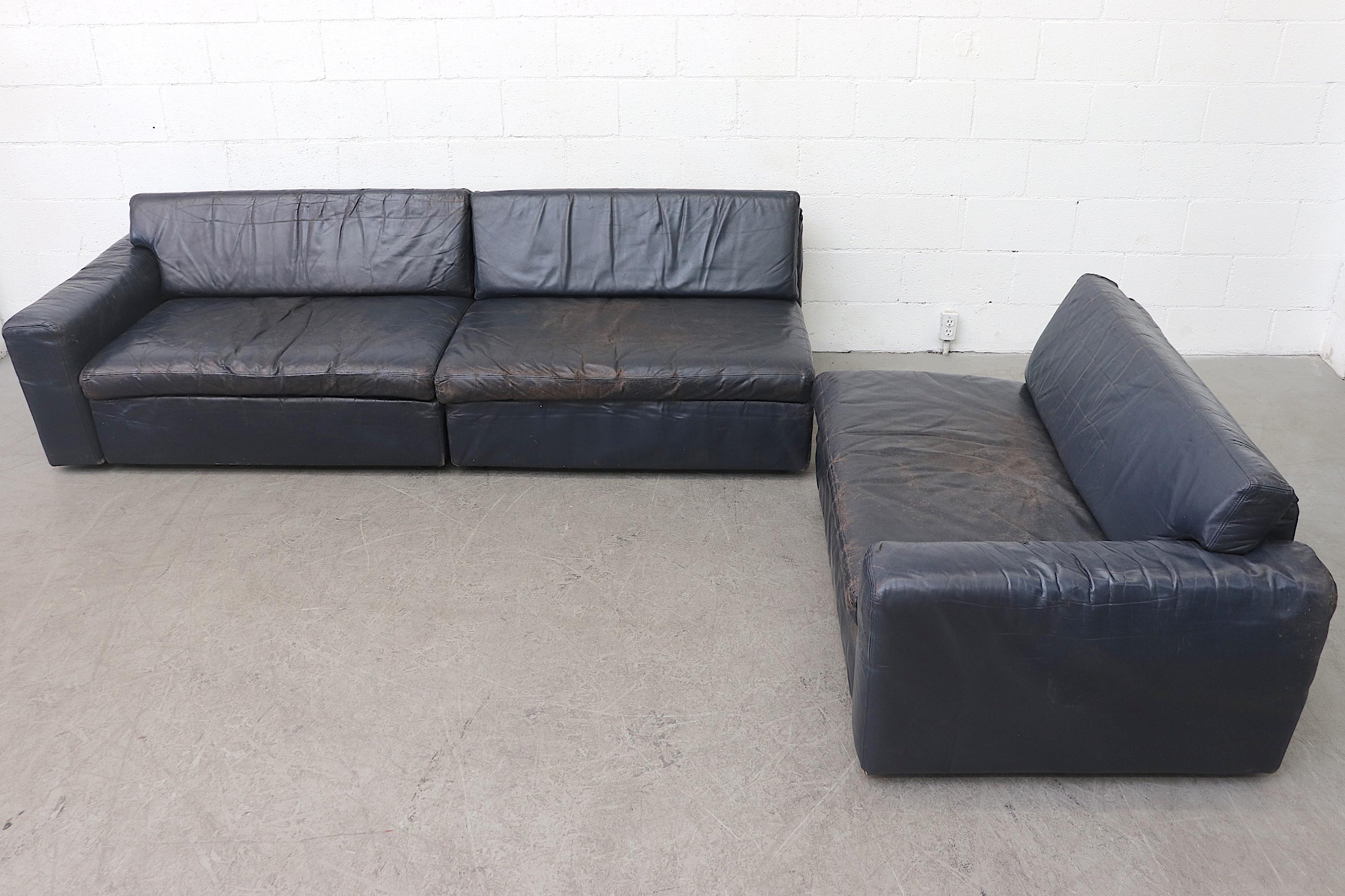 Big, bold, blue leather 3 section sofa in original condition with some visible wear, some leather repairs. Low-seat height. Perfect for casual lounging.