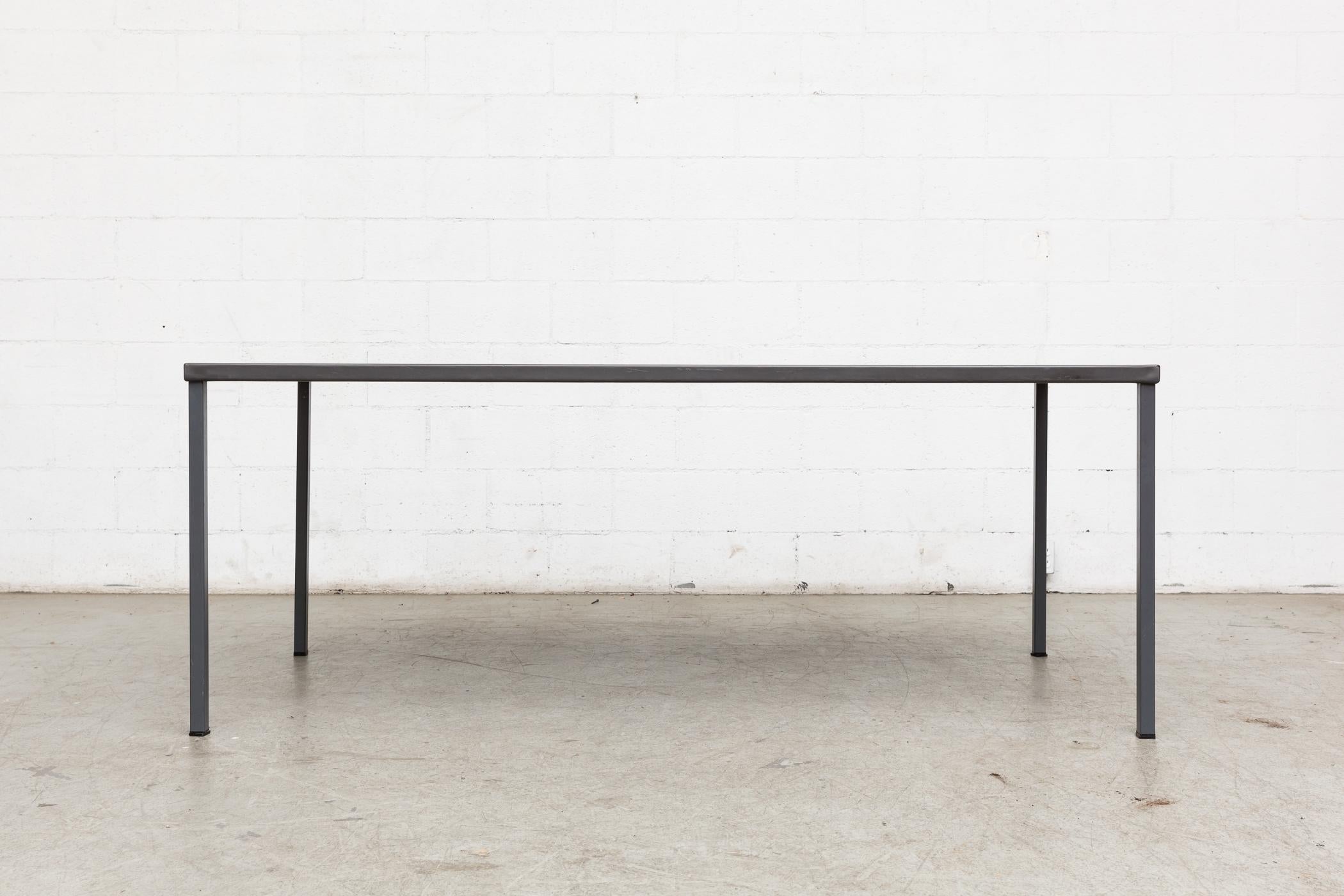 Midcentury industrial dining or conference table. Grey enameled metal frame. Grey/blue linoleum top. Original condition, visible wear.