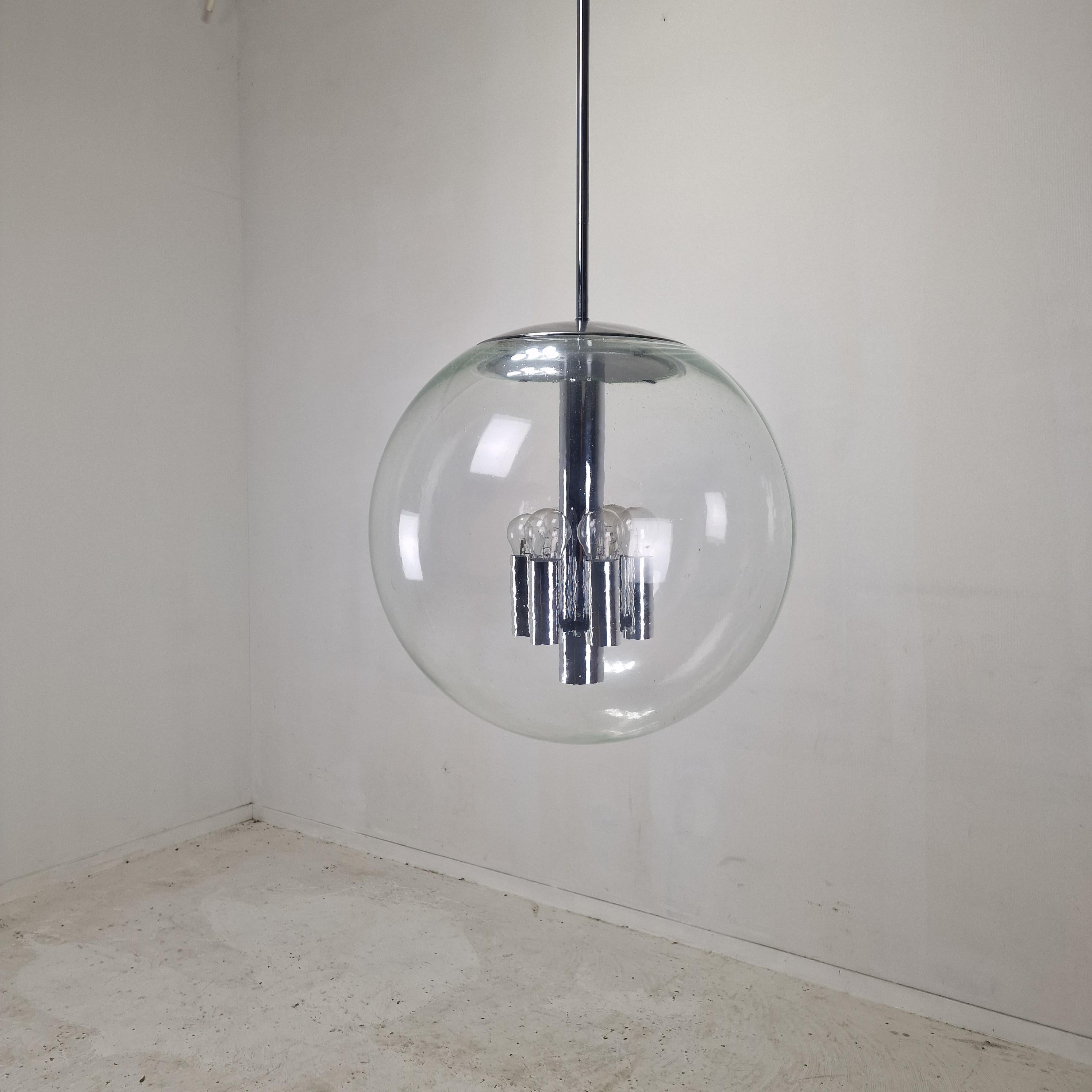 This impressive extra large pendant light by Glashütte Limburg features a striking minimalist design with a large glass globe and polished chrome fittings, manufactured in the 80's.

This particular lamp was originally installed in a church.

The