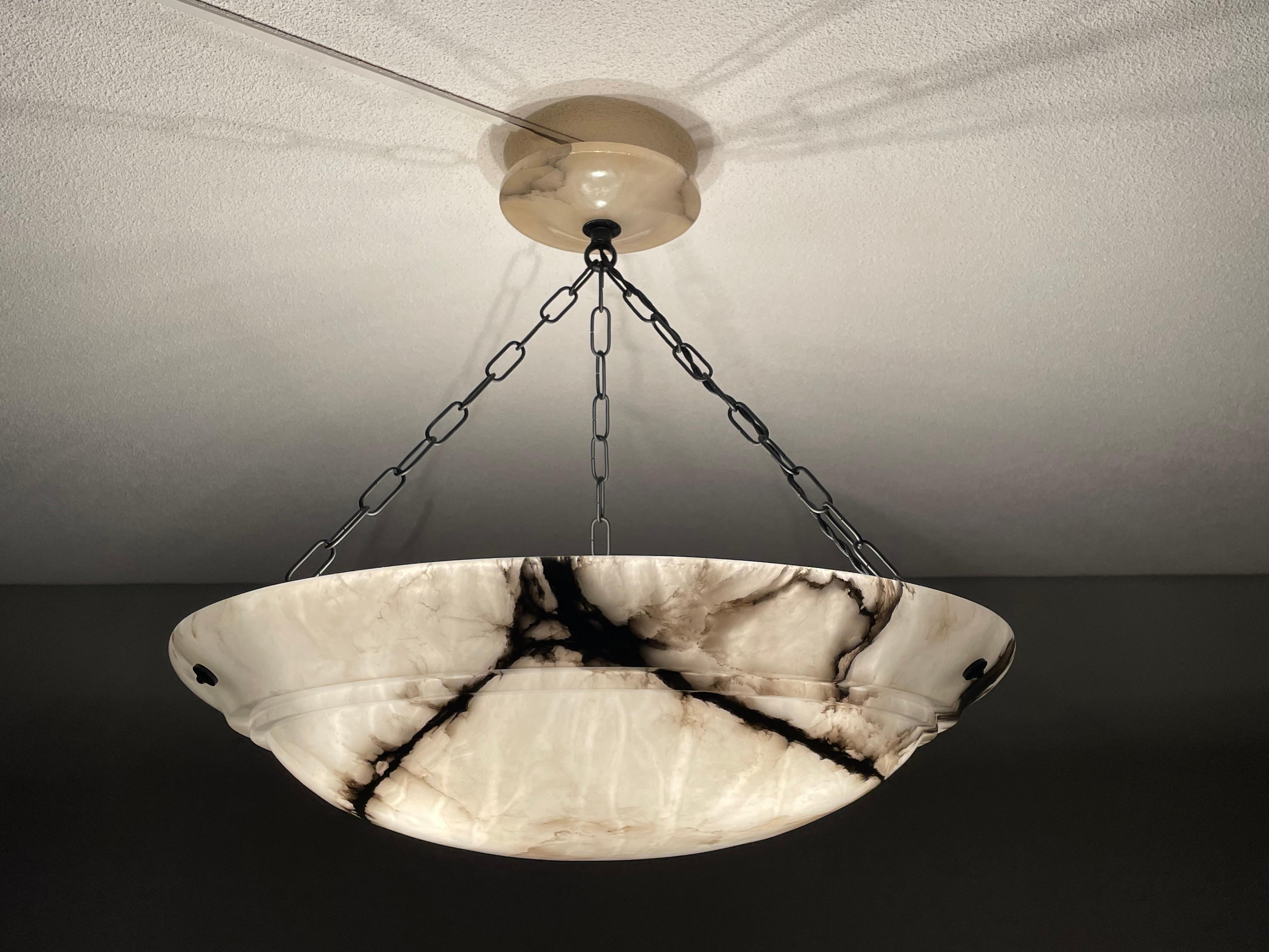 Stunning design and extraordinary size, over 21 inches in diameter antique alabaster light fixture.

Thanks to its extra large size and timeless design this superb condition chandelier from the European Art Deco era is one of the most beautiful
