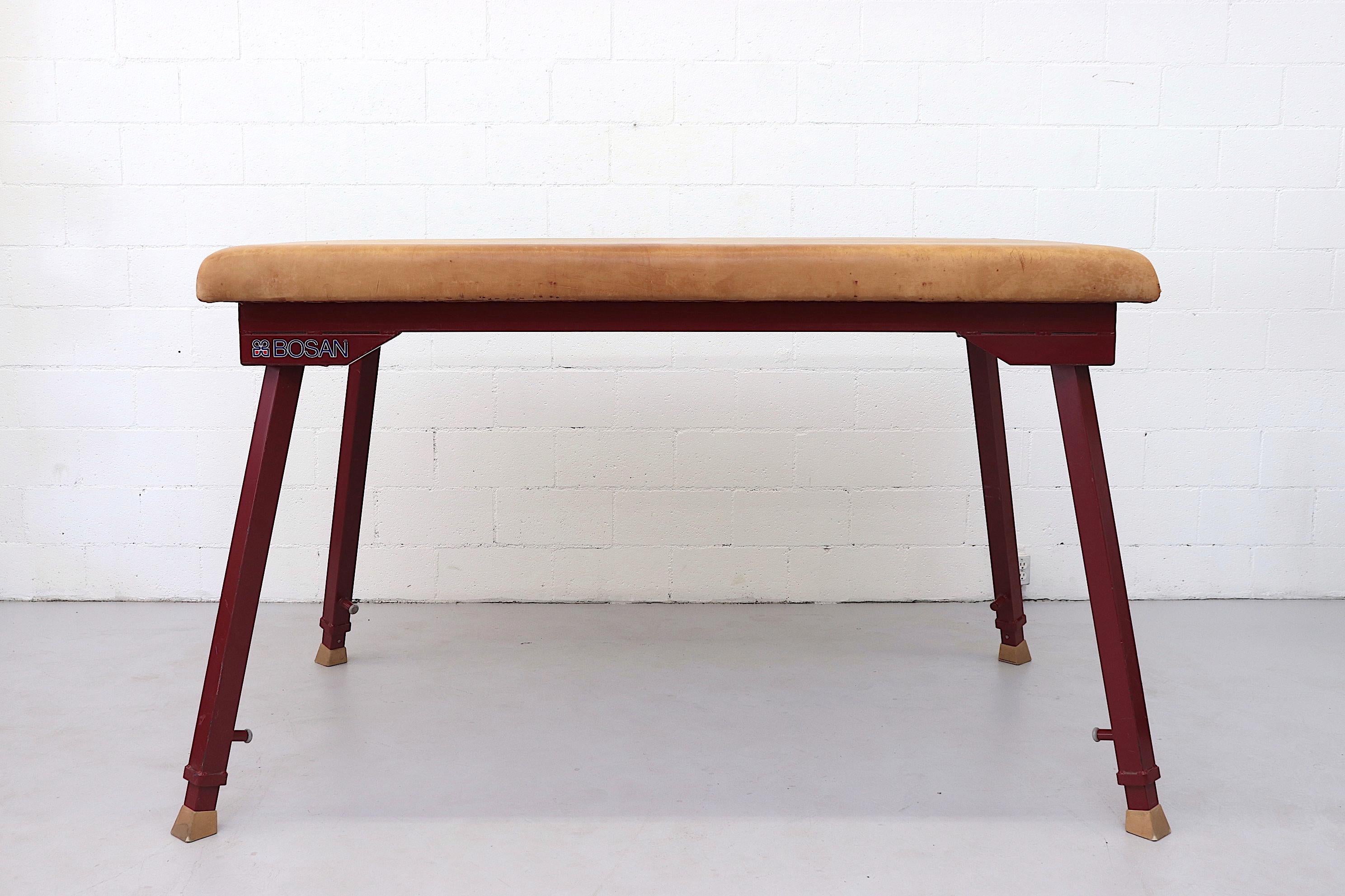 Impressive, Mid-Century, extra large leather gym mat with heavy extendable legs. Manufactured Janssen-Fritsen. Legs can raise up to 5 feet tall. Natural leather top with red enameled metal frame is in original condition with some visible scratches