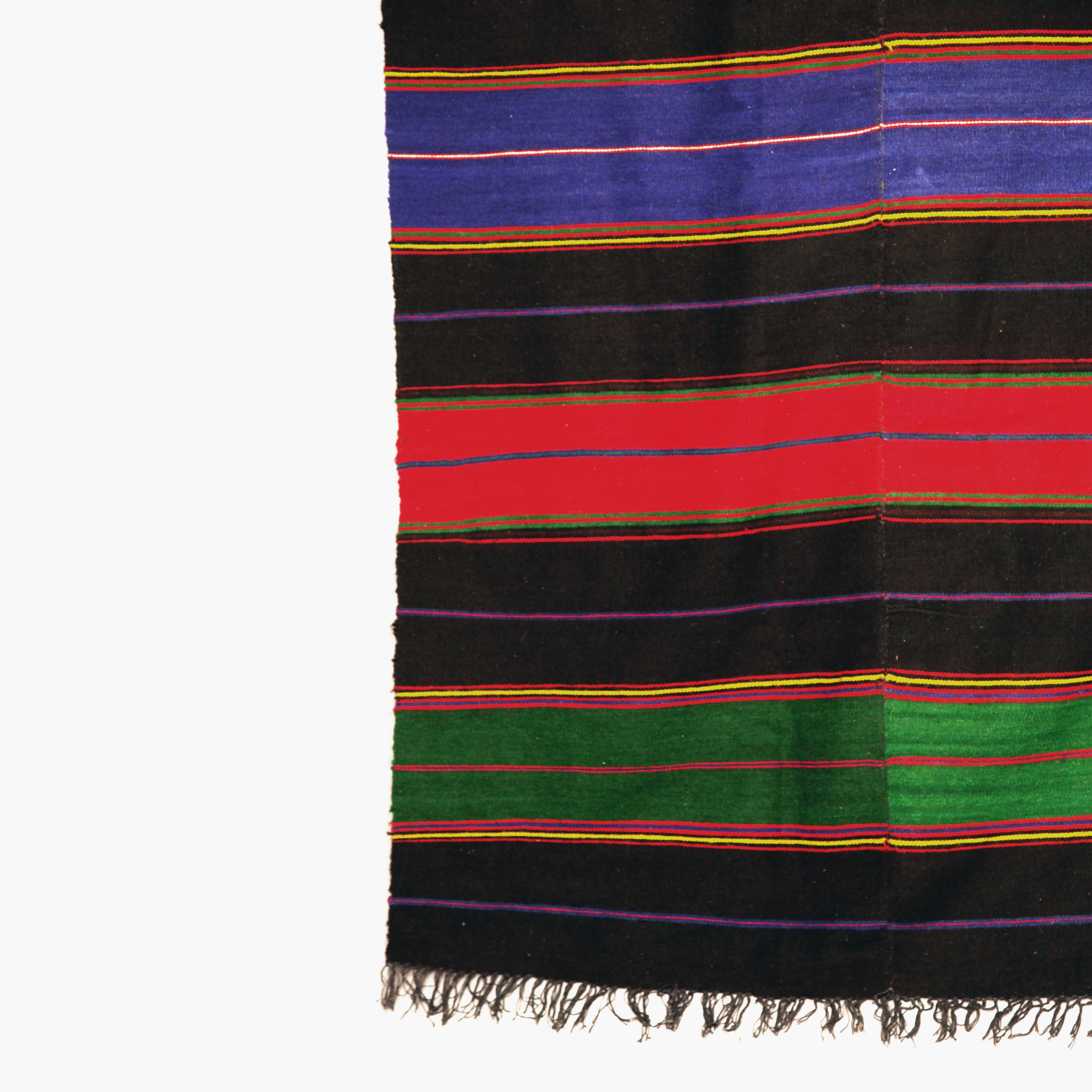 Extra large handmade wool rug in black, green, red and blue stripes. The yarn sourced traditionally and hand-dyed organically. Imported from Greece and more specifically from the mountainous Taksiyarhi village which was famous for its handmade rug