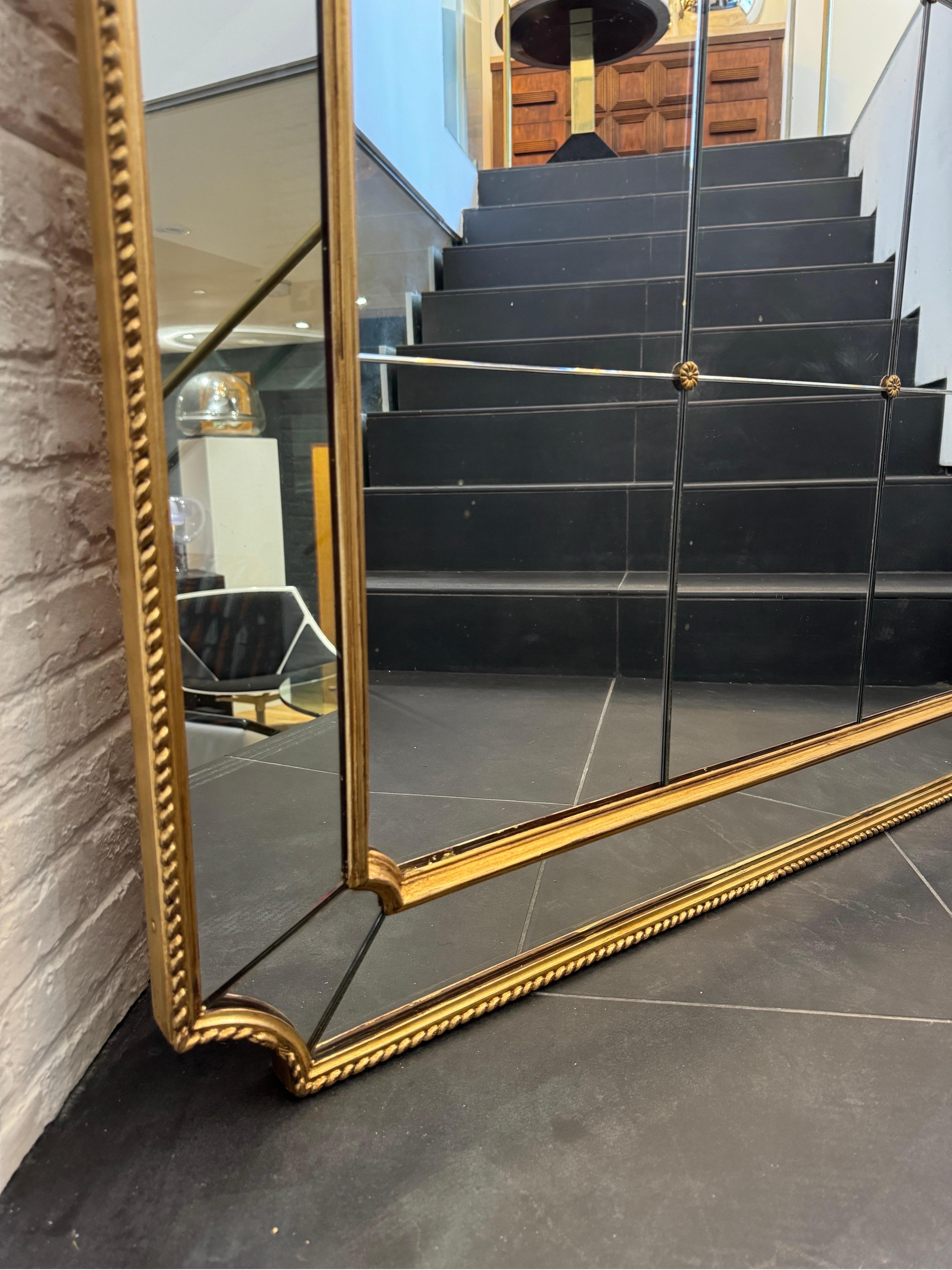 A gorgeous Italian panelled giltwood mirror beautifully decorated with eighteen square glass panels to the centre with decorative flower shaped brass links .
The mirror can be fixed to the wall both horizontally or vertically.
C1940s
Venice
Italy