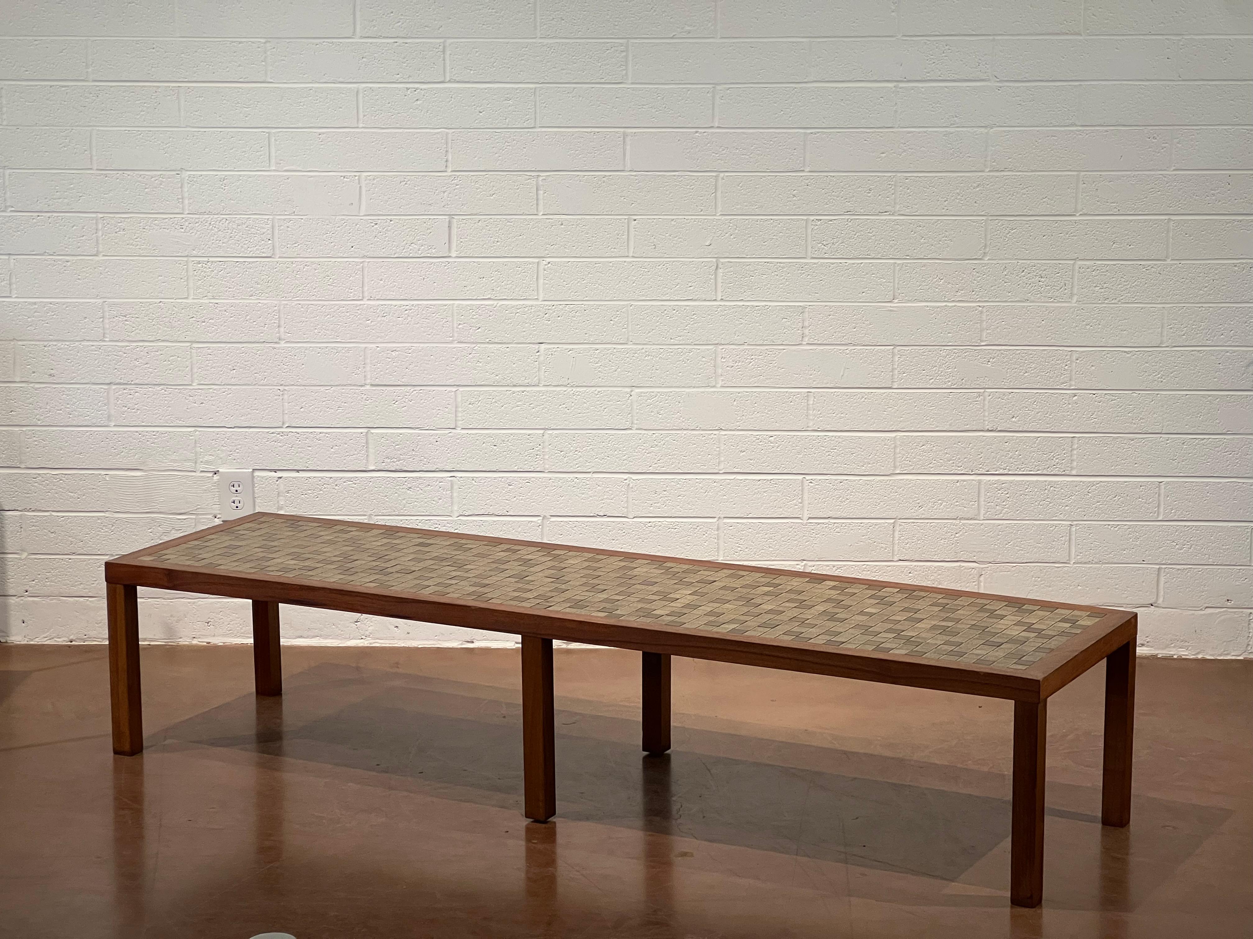 Extra long rectangle coffee table by Gordon and Jane Martz for Marshall Studios. The table top is inlaid with olive and taupe square ceramic tiles and the frame and legs are solid walnut. It is in great condition with very minimal wear. 