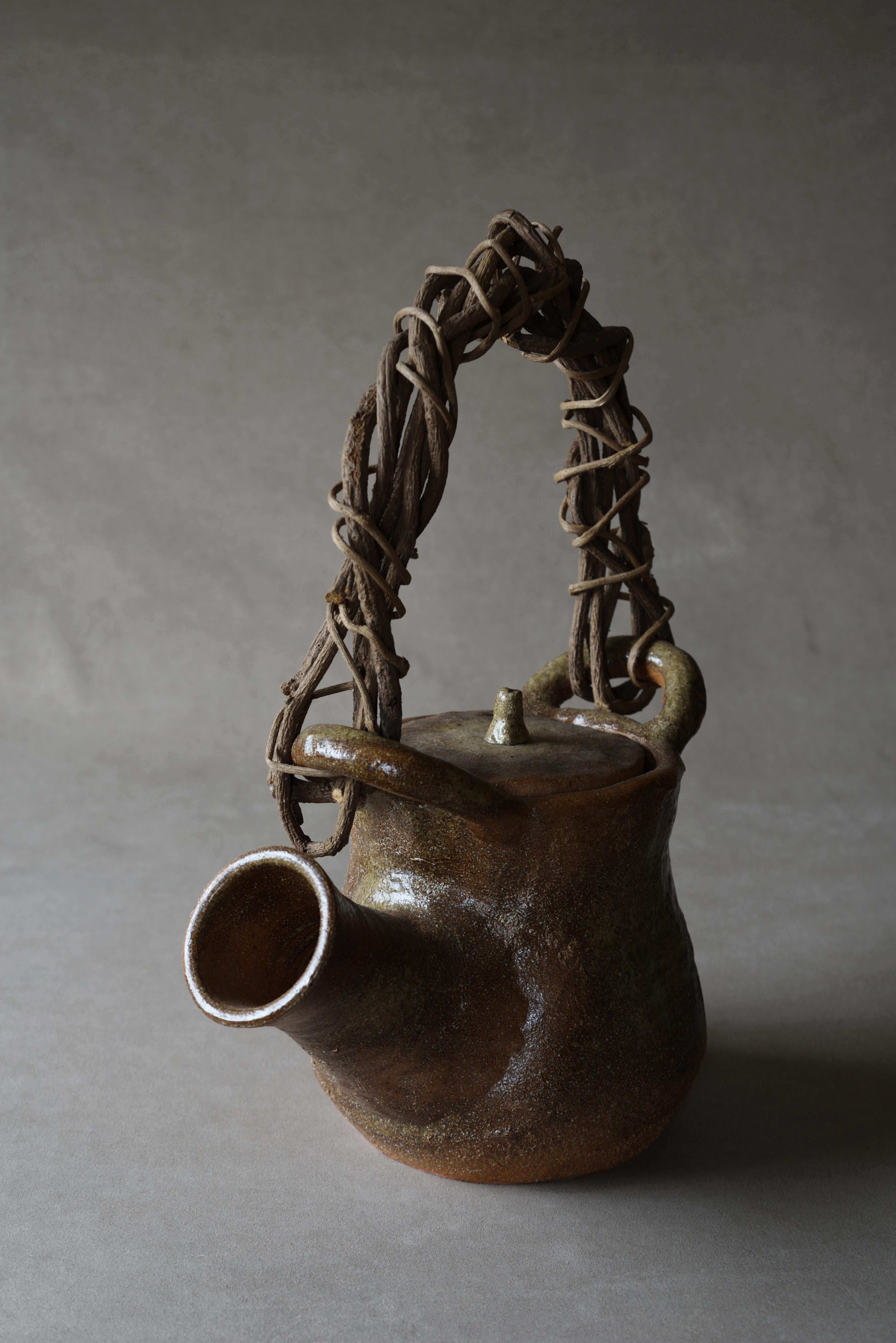 Très grande théière en grès non émaillé Shigaraki avec anse en vigne sauvage, période Showa, 20e siècle, Japon, approx. H 44 x 35 x 19cm (17.32 x 13.77 x 7.48in)

 