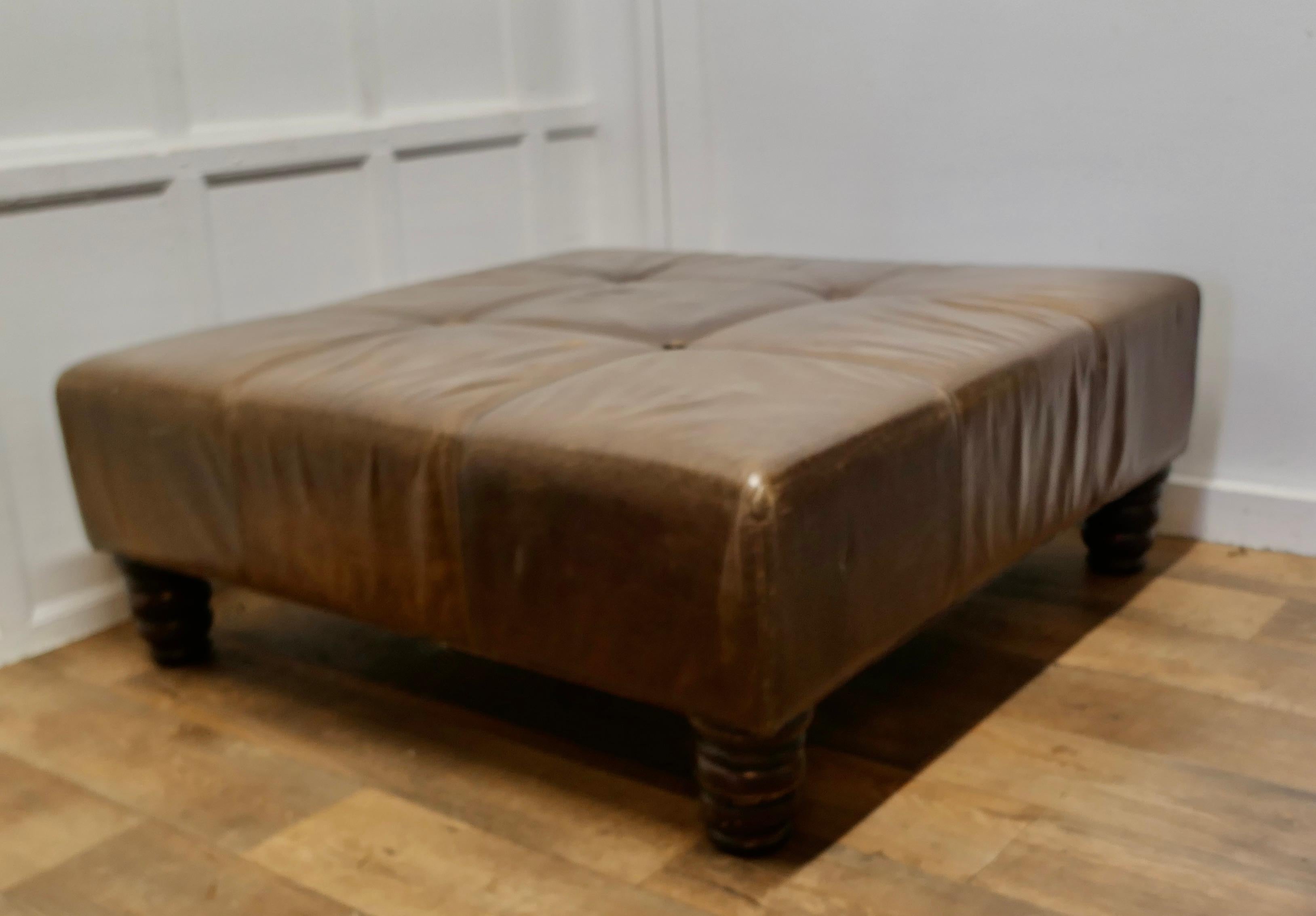 Extra Large Leather Chesterfield Ottoman Seat or Centre Coffee Table 

This is a real statement piece the 10” deep top is upholstered in superbly tactile soft brown leather, it is set on chunky Victorian turned feet, the leather is heavy quality and