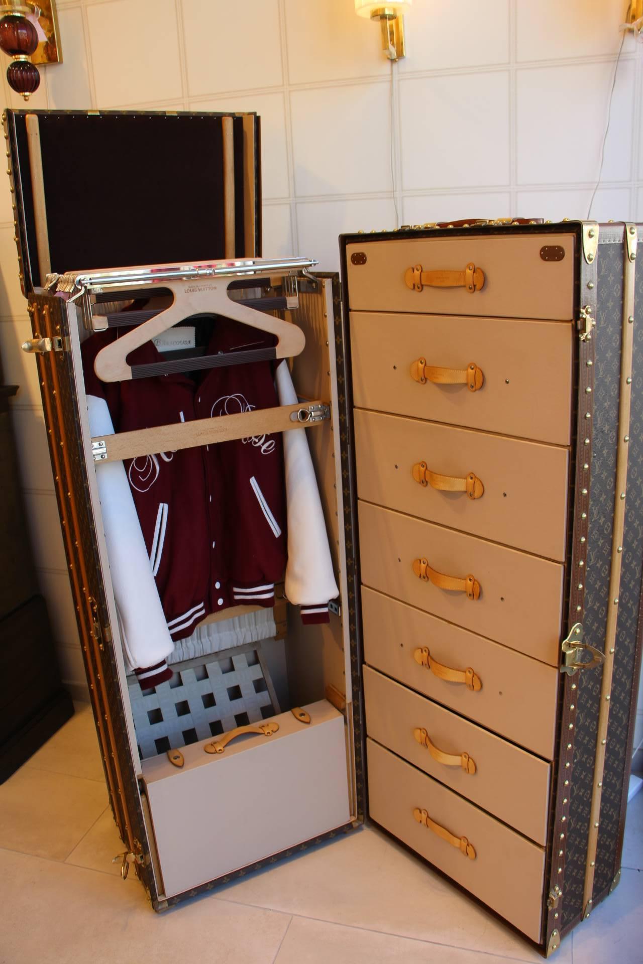 This impressive Louis Vuitton wardrobe features monogramm canvas, lozine trim, LV stamped solid brass locks and studs as well as solid brass corners.

It has got a lift top that closes thanks to two brass locks.

Its interior is remarkable with