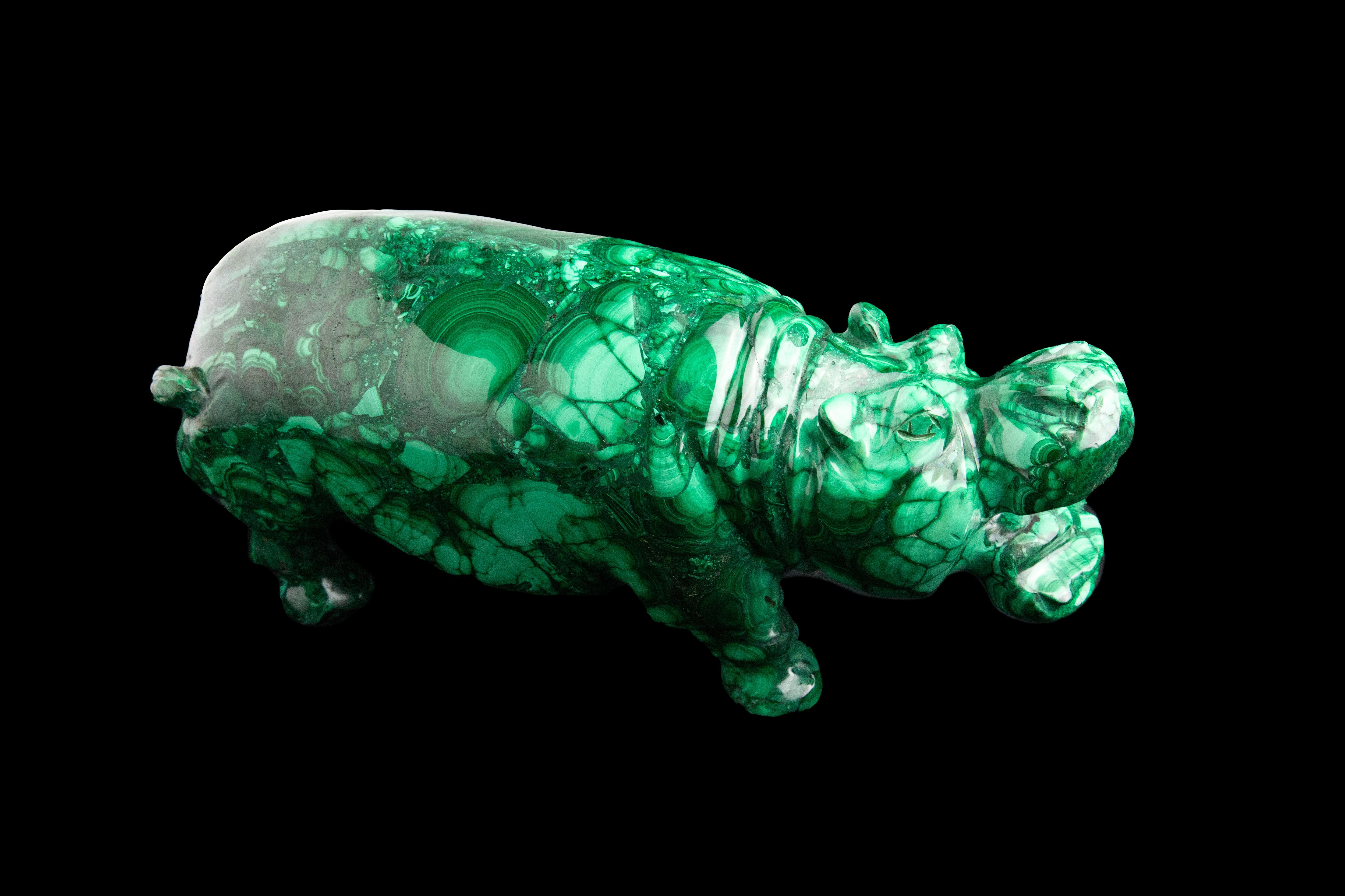 This hand carved Malachite Hippo is a stunning piece of art that will add beauty and elegance to any space. The hippo is extra large, measuring 11 inches long, 4 inches wide and 5 inches tall. It weighs 12 pounds and has a smooth and glossy surface