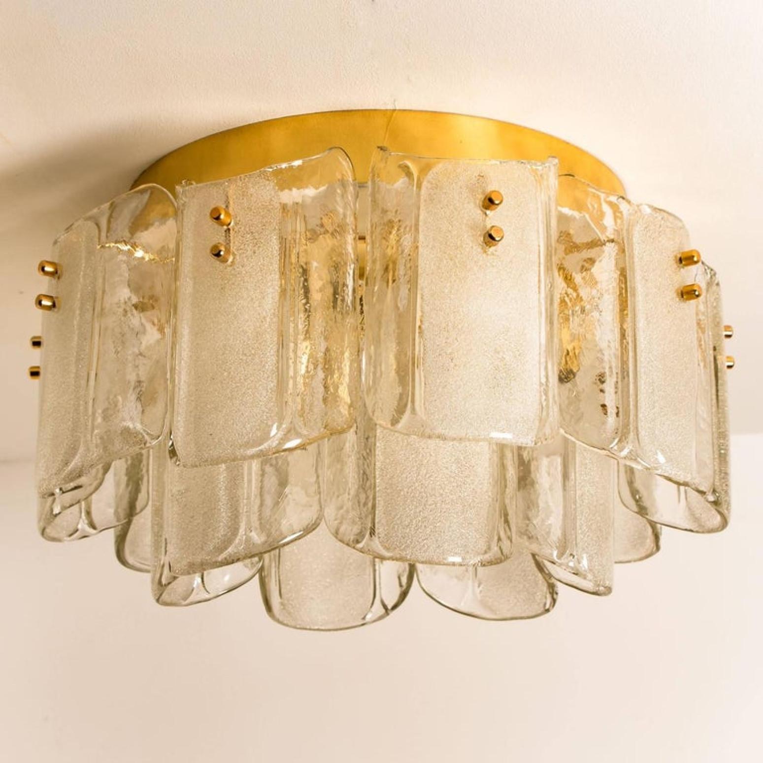 Unique large and elegant glass flush mount in the style of J.T. Kalmar, manufactured in mid century, circa 1970 (late 1960s or early 1970s. wonderful high-end light fixtures with brass detail and 16 thick textured blown glass sheets, 1969.
The glass