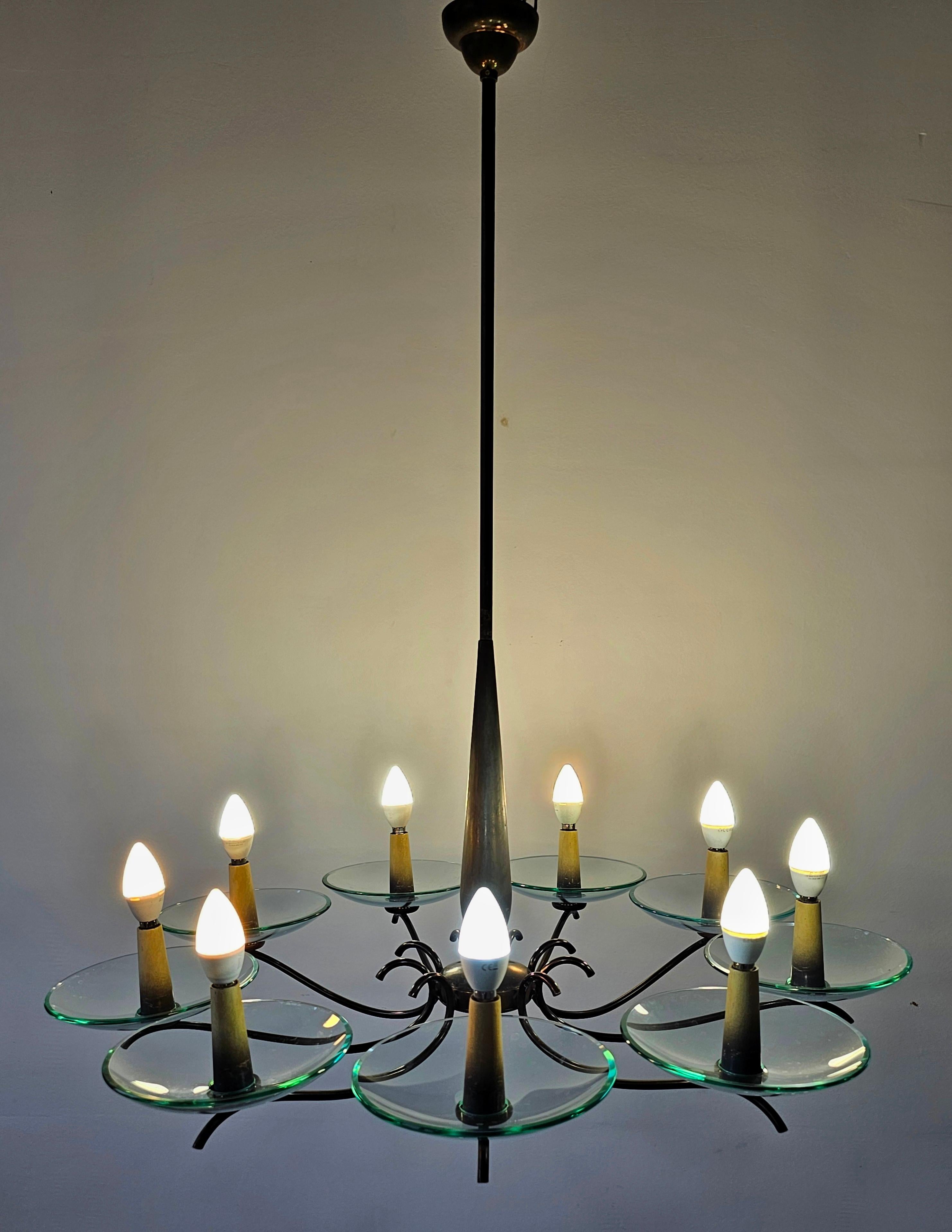 In this listing you will find a gorgeous extra large Mid Century Modern 9-arm chandelier done in brass and Murano glass. It was designed in style of Pietro Chiesa. Made in Italy in 1950s.

Very good vintage condition.
Due to its size the chandelier