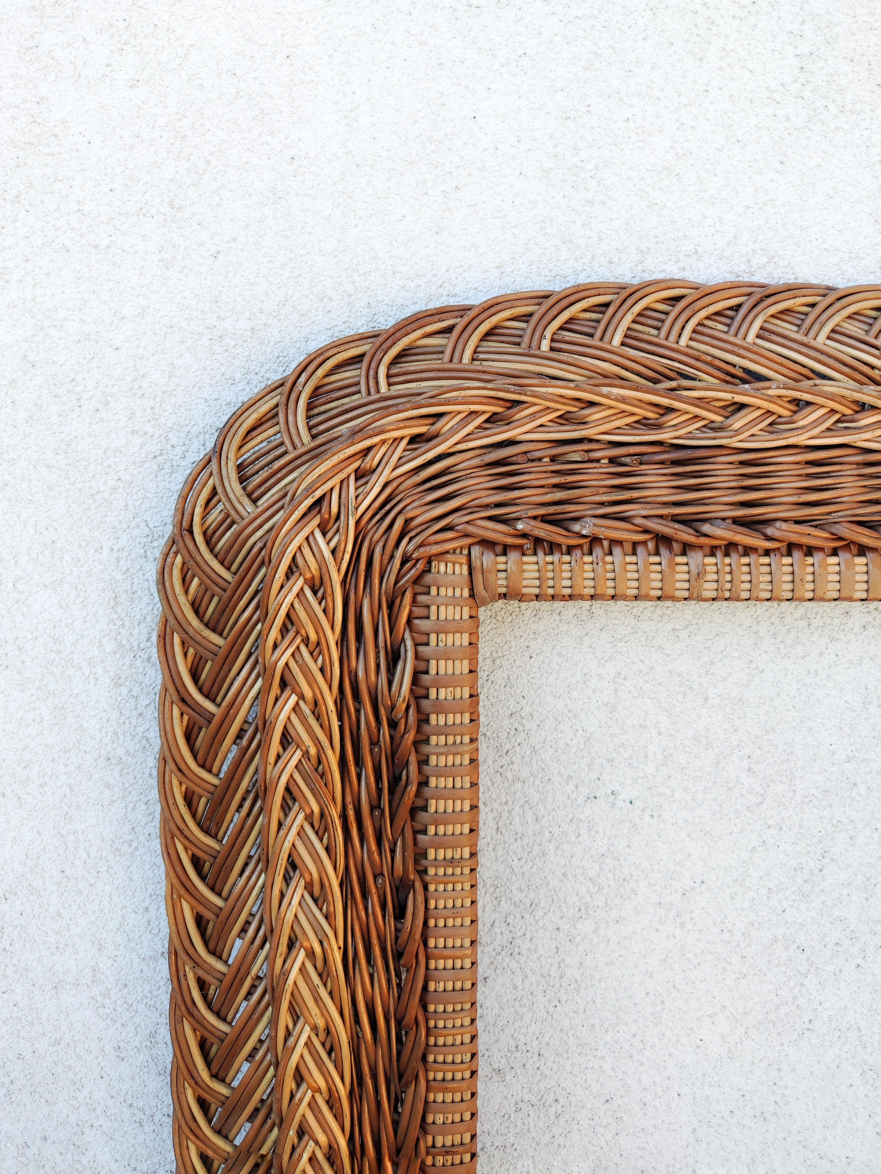 In this listing you will find a striking extra large Mid Century Modern Mirror rectangular Frame done in hand-woven natural rattan. Made in Italy in 1960s.

It shows some signs of time and use, like some fading and a small part where the couple of