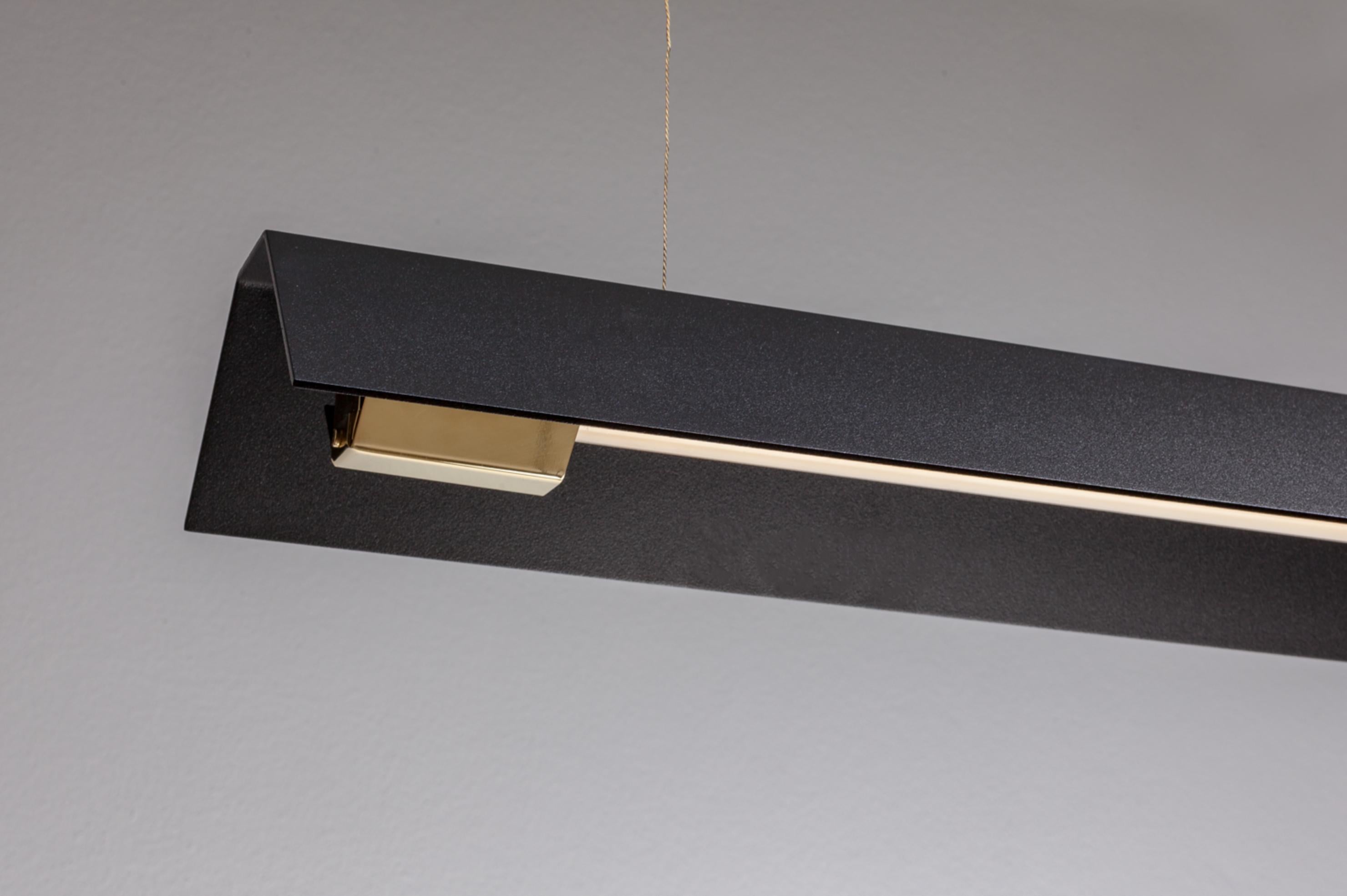 Extra large misalliance ex jet black suspended light by Lexavala.
Dimensions: D 16 x W 160 x H 8 cm.
Materials: powder coated shade with details made of brass or stainless steel.

There are two lenghts of socket covers, extending over the LED.