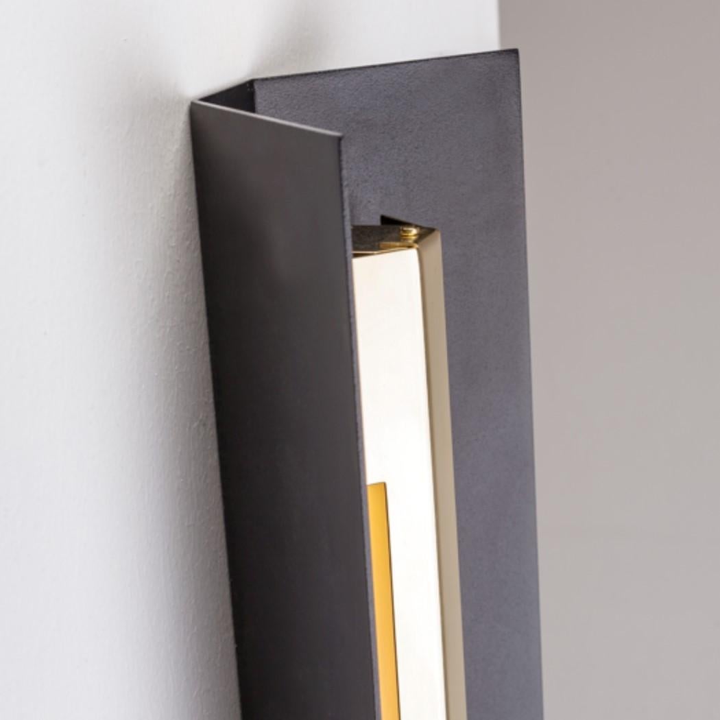Extra Large Misalliance Ex jet black wall light by Lexavala.
Dimensions: D 16 x W 160 x H 8 cm.
Materials: powder coated shade with details made of brass or stainless steel.

There are two lenghts of socket covers, extending over the LED. Two