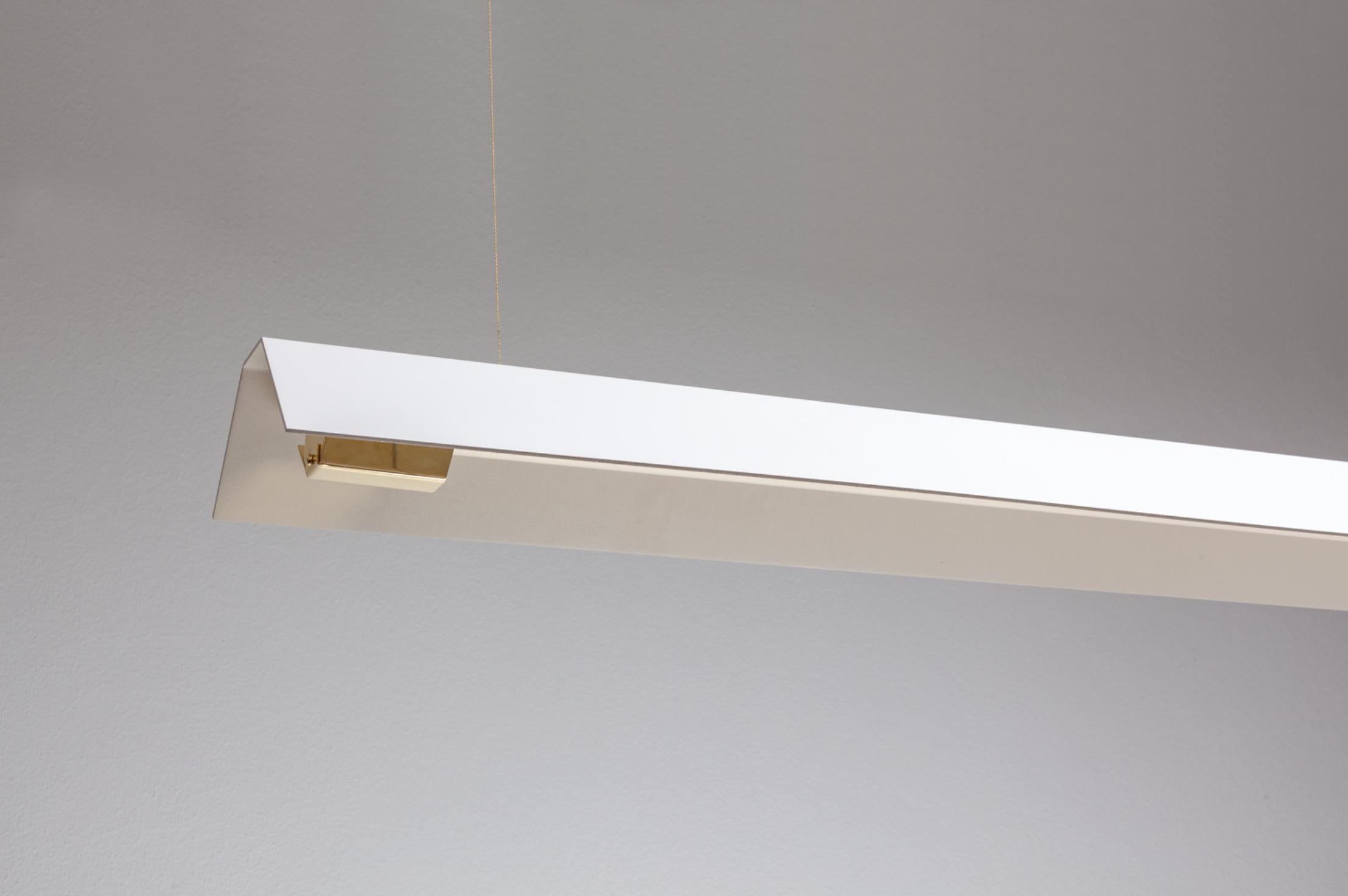 Extra Large Misalliance Ex pure white suspended light by Lexavala.
Dimensions: D 16 x W 160 x H 8 cm.
Materials: powder coated shade with details made of brass or stainless steel.

There are two lenghts of socket covers, extending over the LED.