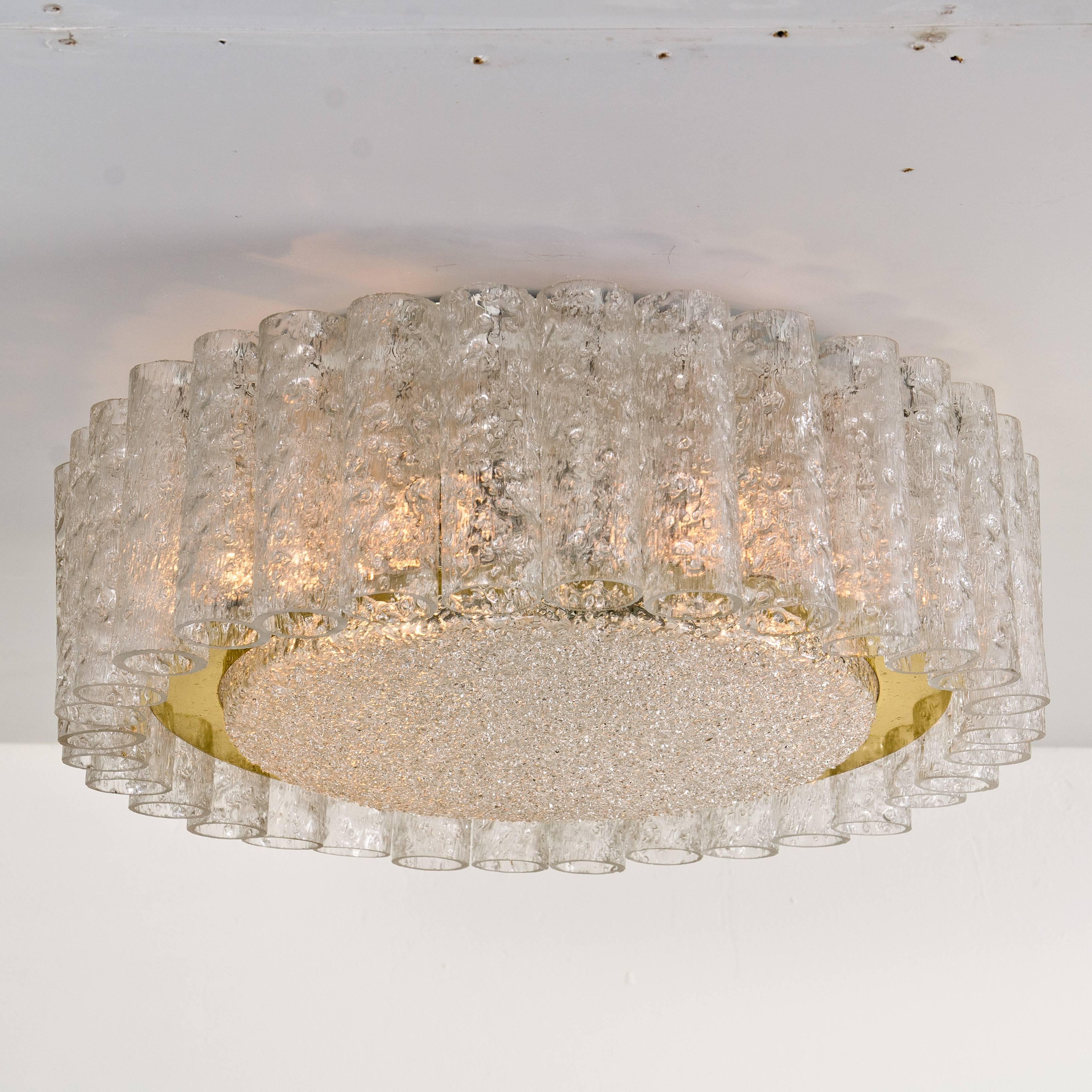 A extra large Doria flush mount chandelier, organic glass tubes surrounding a central glass diffuser mounted with minimal exposed hardware with a brass ring for a clean and elegant look.

The glass dishes of the fixtures  are made of 'Frit' glass - 
