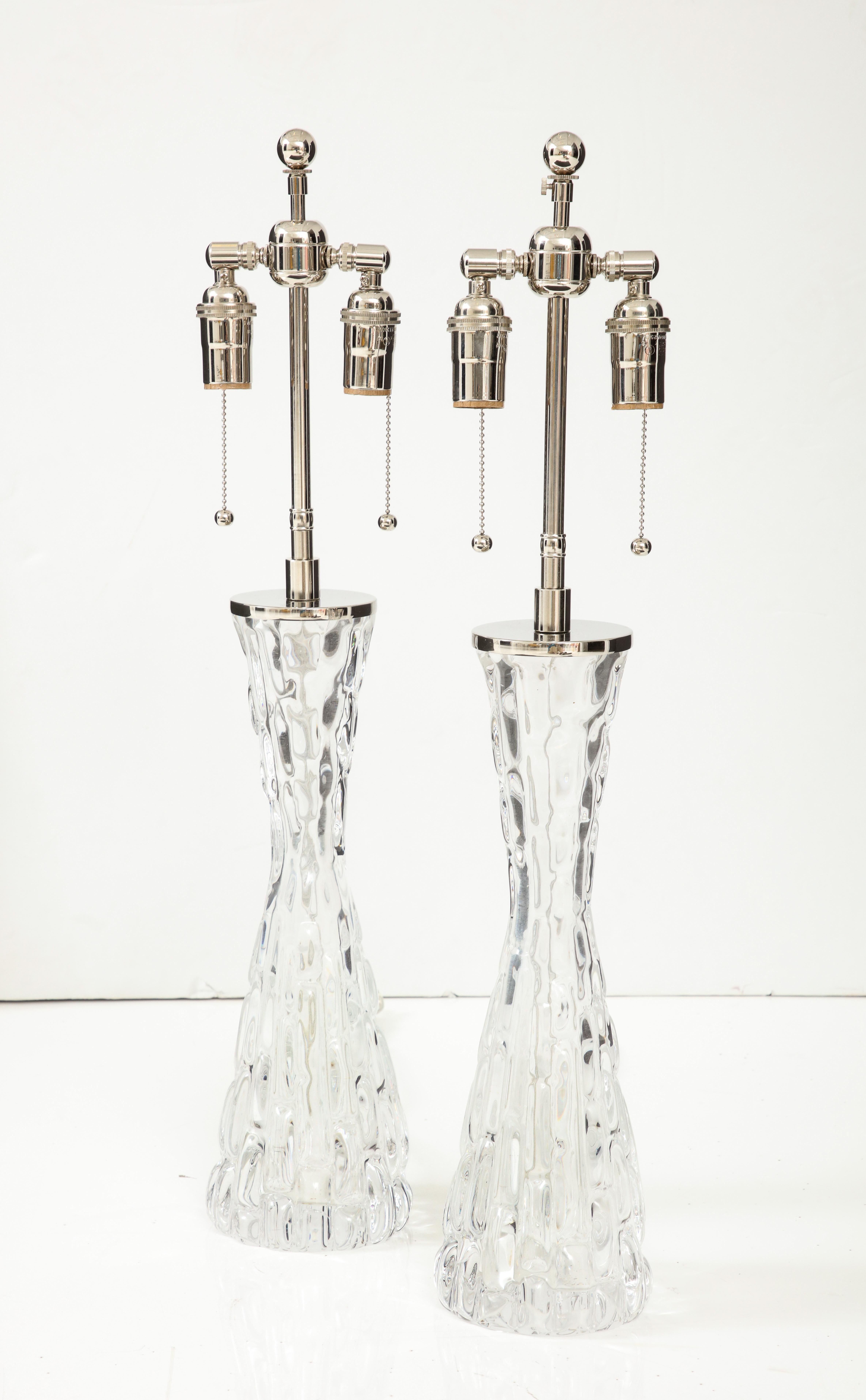 Pair of 1970's Extra large heavy Crystal lamps designed by Carl Fagerlund 
for Orrefors.
The lamps have been newly rewired with polished chrome adjustable double clusters that take standard size light bulbs.
60 Watts per socket / 120 watts per