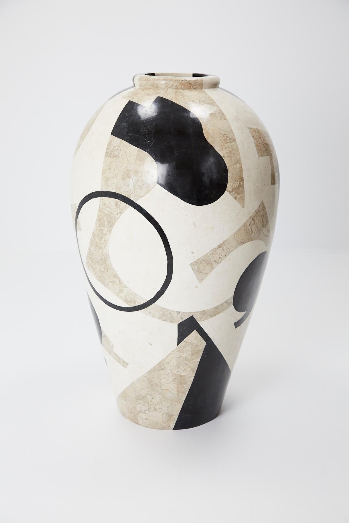 Extra large, oversized mango jar executed in fiberglass with black, cream, and tan tessellated stone covering the exterior in a fun postmodern pattern. Excellent size for a floor vase or planter. Measures 42 in. tall.

All furnishings are made from