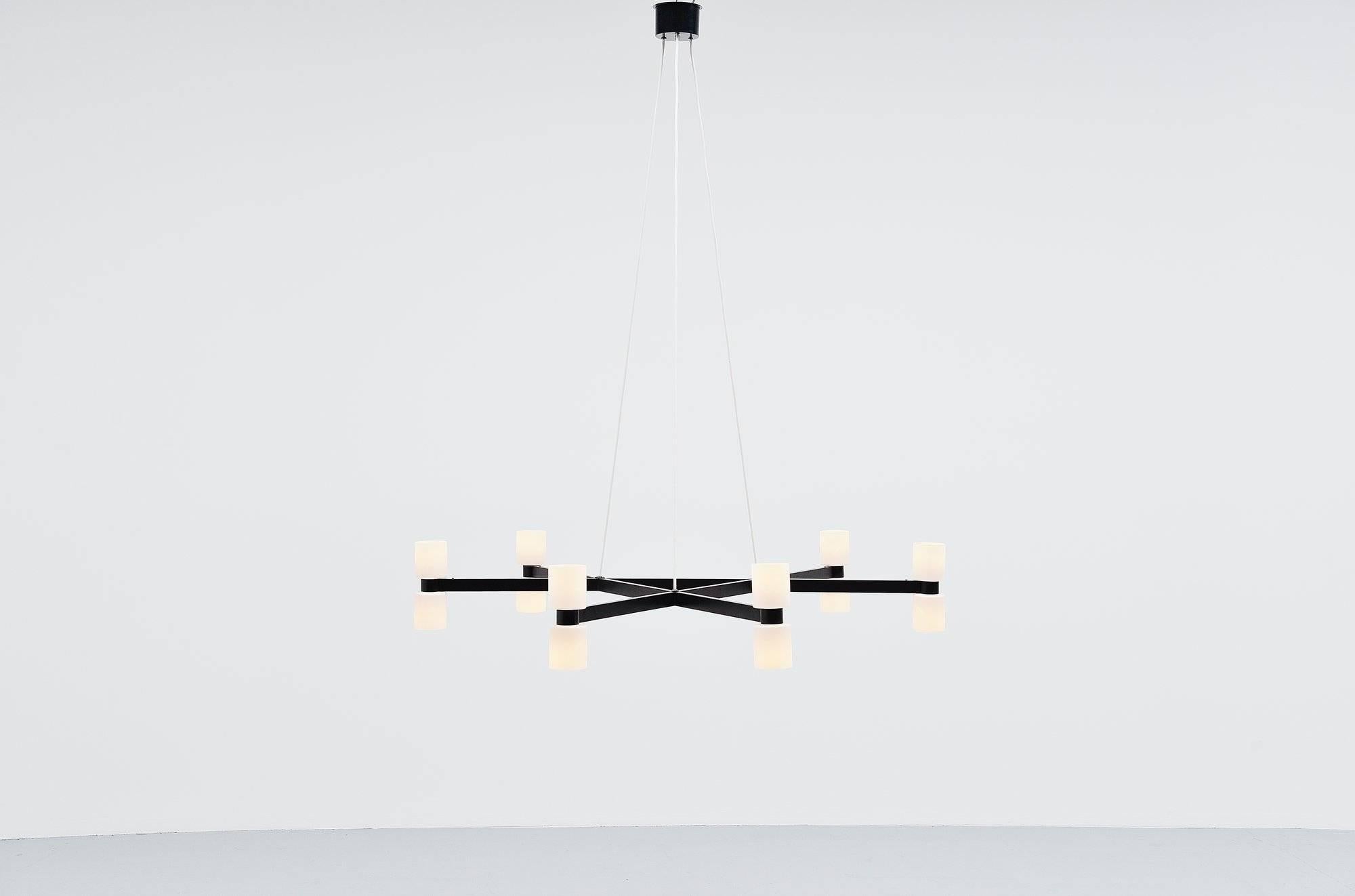 Extremely large chandelier designed by J.W. Bosman and manufactured by RAAK Amsterdam, Holland 1965. These lamps have a large star shaped frame made of black painted metal, the frame hands on three electrical white wires and the ceiling plate is