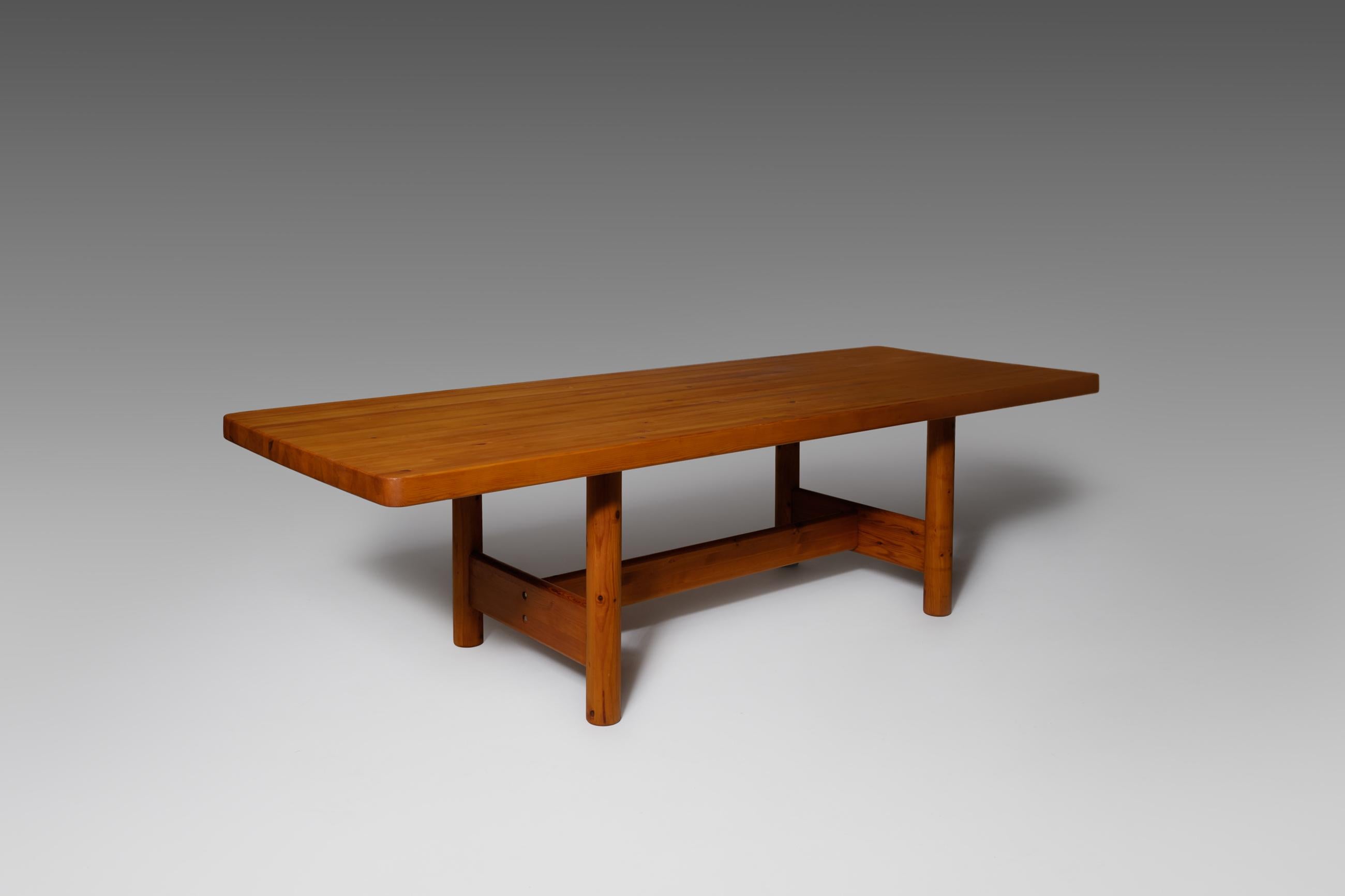 Rare extra large dining table by Rainer Daumiller, Denmark, 1970s. The large and heavy table top is constructed of layers of solid pine slats which creates an interesting pattern. The large top lays on modest strong base with four solid cylinder
