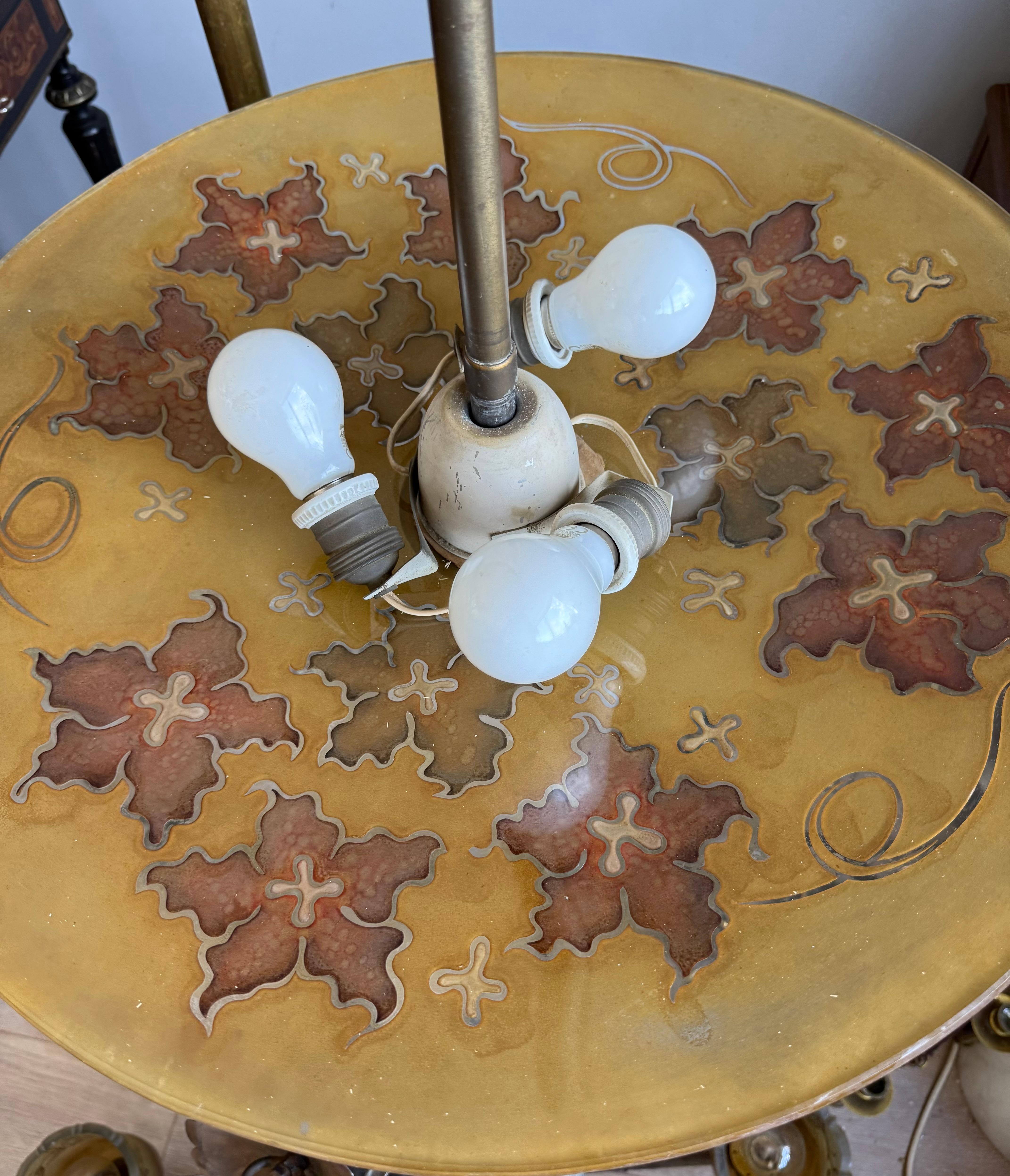Impressive thick Art glass pendant light with leaf sculptures in relief.

This great early 20th-century pendant is a fine example of craftsmanship from a bygone era, when lighting was not only functional but also an Art form. The large, hand-blown