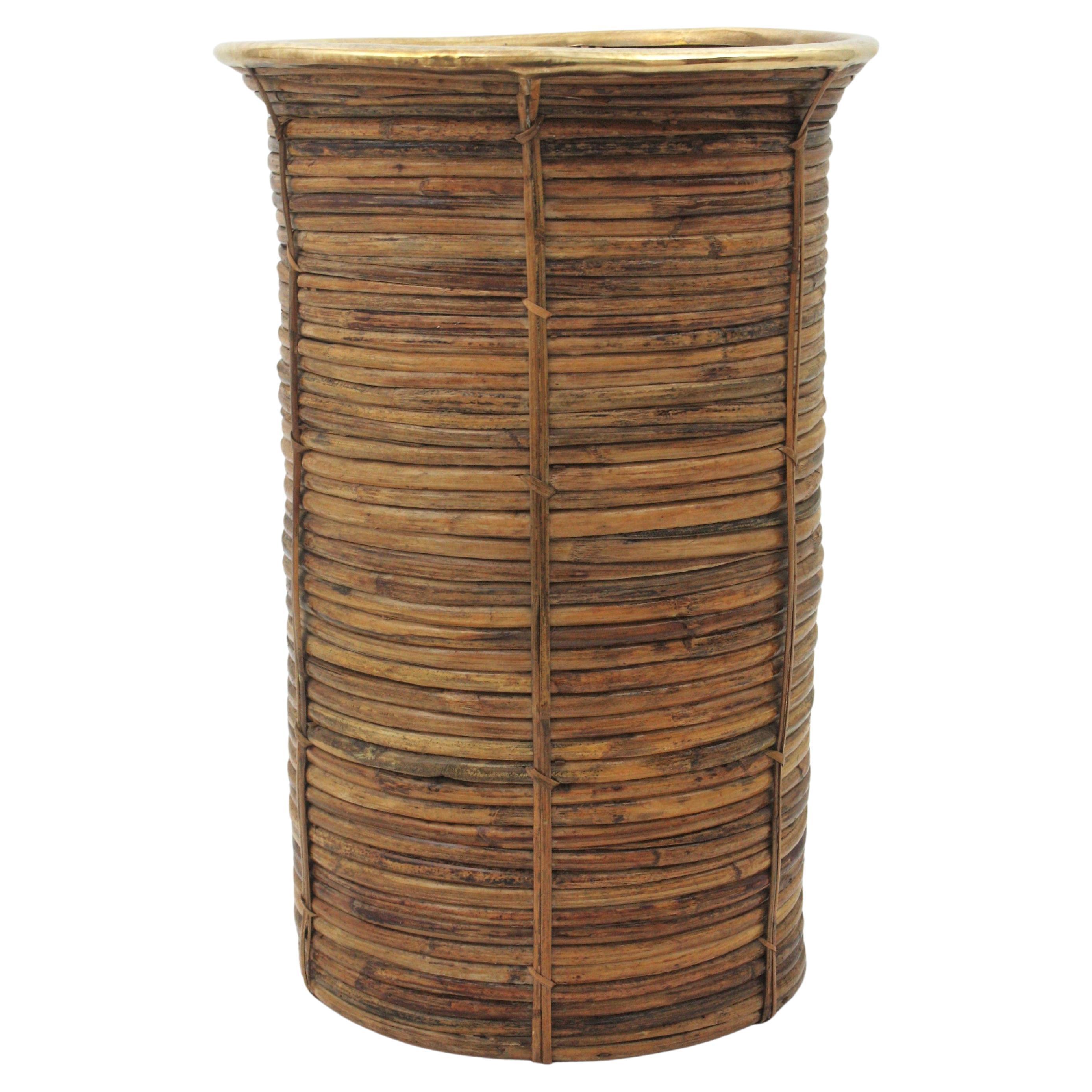 Beautiful Mid-Century Modern decorative brass and bamboo / rattan large umbrella stand. Handcrafted in Italy, 1970s.
Rare find in this XL size.
Round shape rattan structure with brass open rim. It has reminiscences of Gabriella Crespi designs.
This