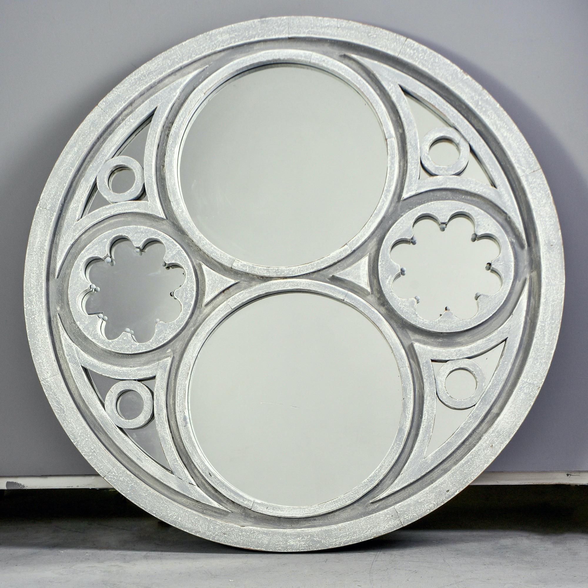Round framed Swedish style mirror is 52” in diameter, circa 2010. Decorative cutout in frame and gray blue painted finish. Unknown maker.