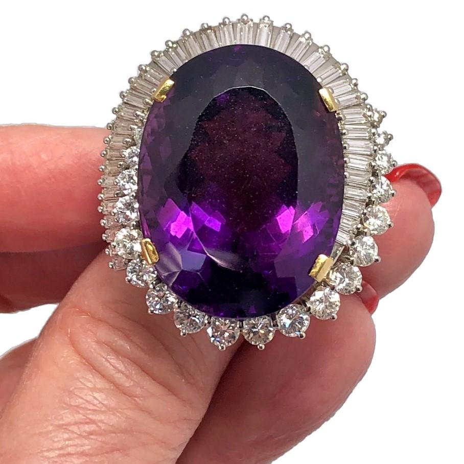 Exquisitely hand crafted from 18k yellow gold and
platinum and set at it's center with a rich color and 
internally clean Brazilian Amethyst weighing 
approximately 33.00ct. Surrounding the center stone 
are fifty six straight baguette and brilliant