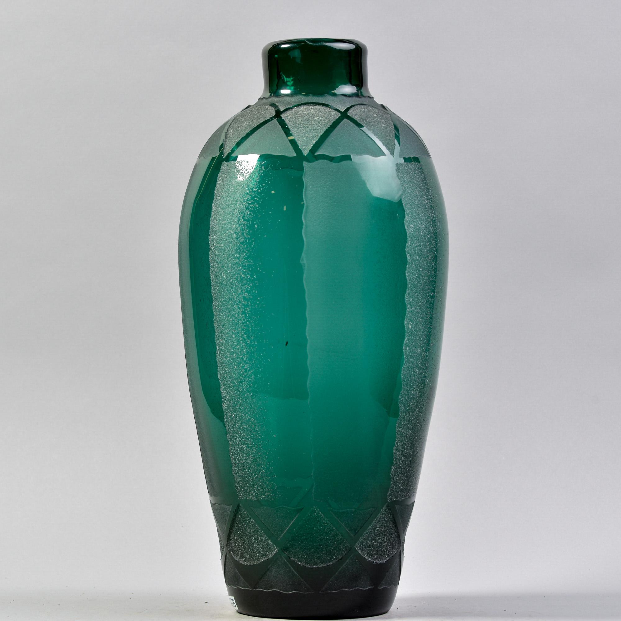 Standing just under 20” tall, this Art Deco vase was found in France. Marked VerArt on underside of base, this was a 1930s division of famed French art glass maker Sabino. This vase features deep green art glass with acid-etched Deco design