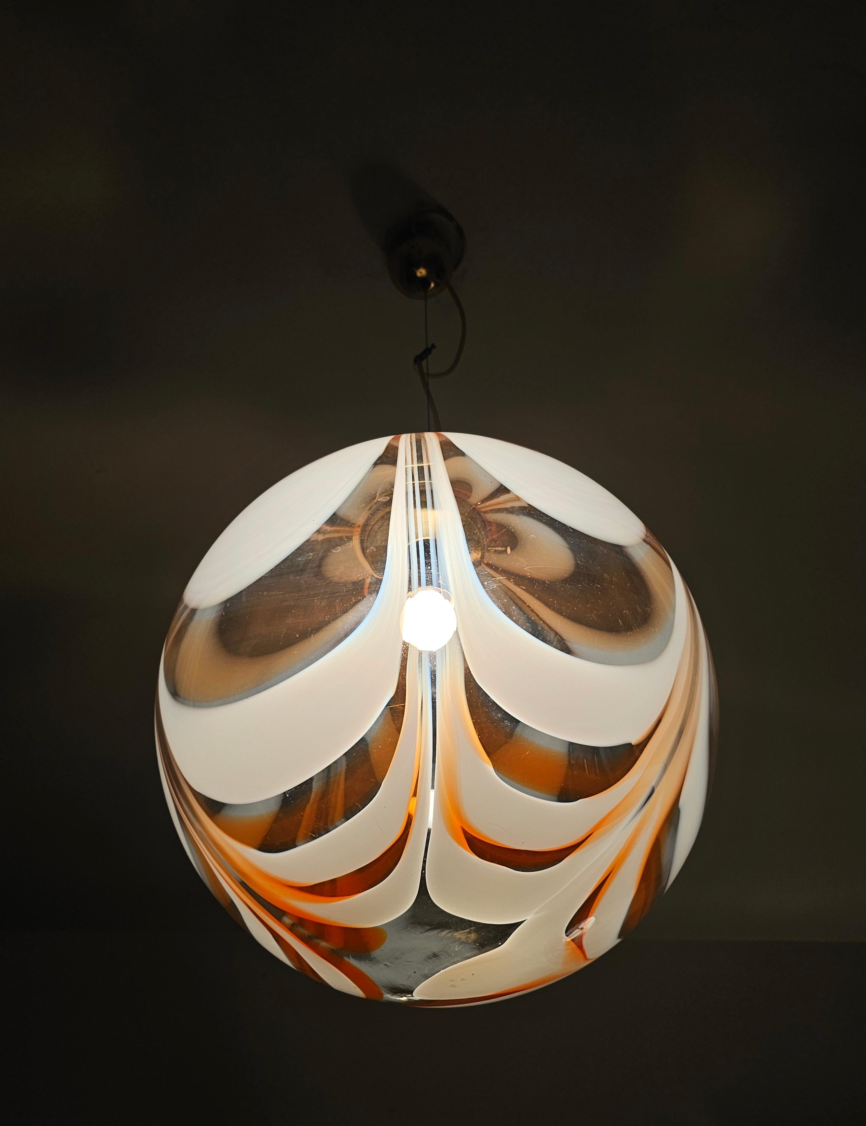 This listing features an exquisite, extra large pendant, done in Murano glass. This pendant is done out of a single piece of mouthblown glass in three colors. It is very delicate and elegant piece of lighting that will work great in the rooms with