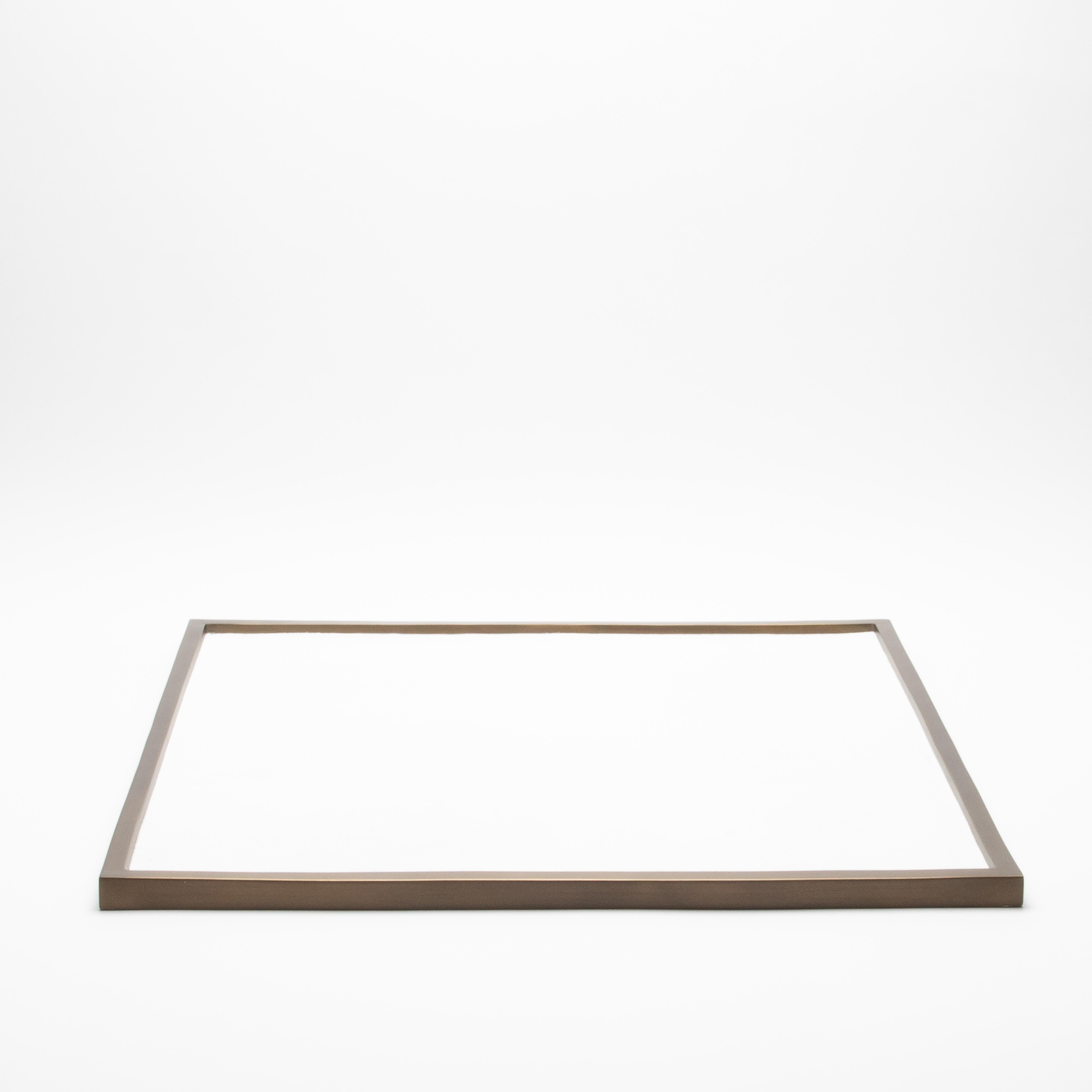 Questo vassoio quadrato extra-large di Kifu Paris presenta una lussuosa superficie in zigrino bianco incorniciata da una patina di bronzo in ottone, creando un raffinato contrasto tra texture e metallo. Con i suoi 30 pollici per lato, il suo design