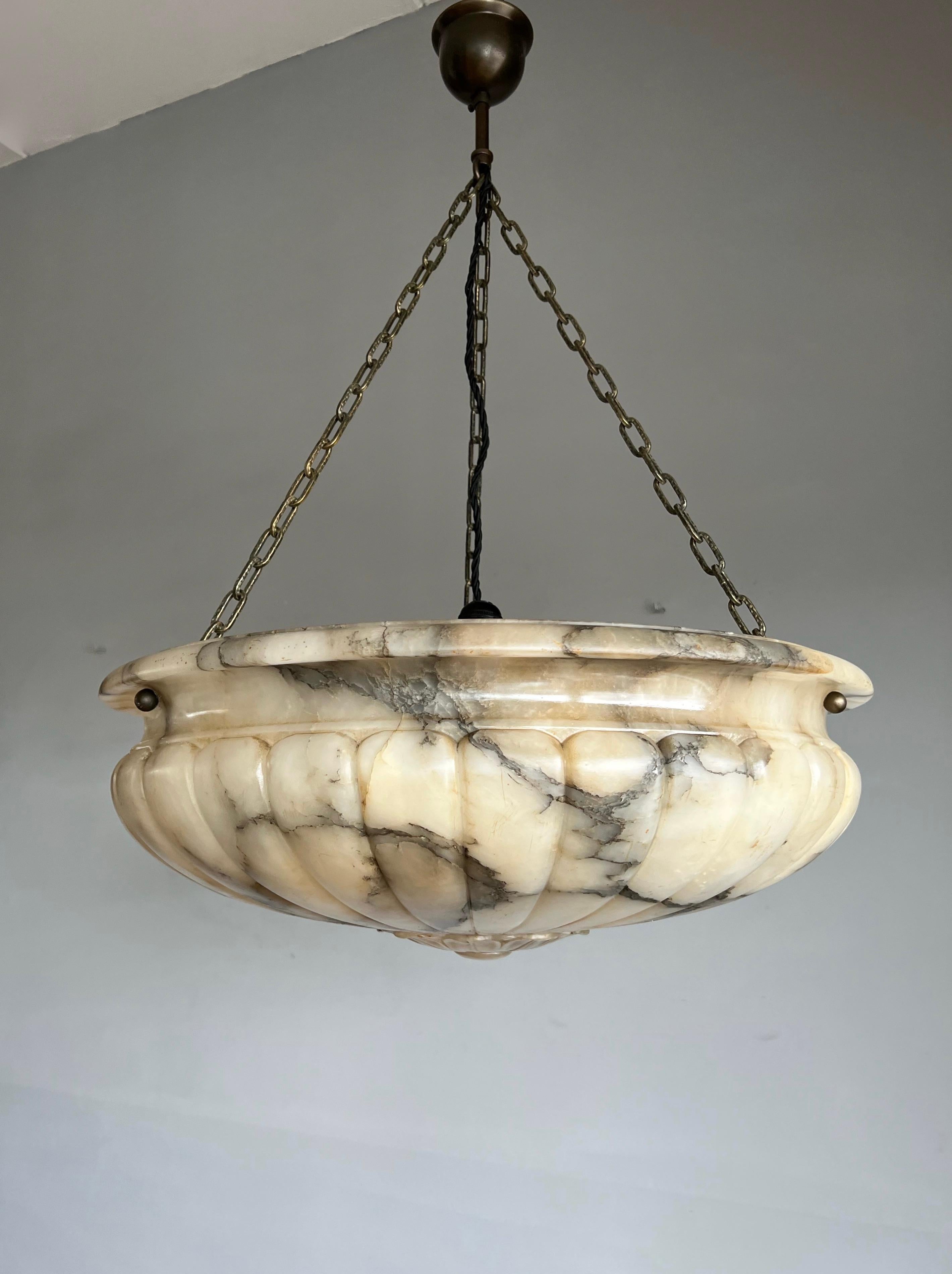 Large size and great design, hand carved, antique alabaster chandelier.

Thanks to its very large size & deep shape this remarkable alabaster chandelier will light up both your days and evenings. The profesionally restored shade is again in the