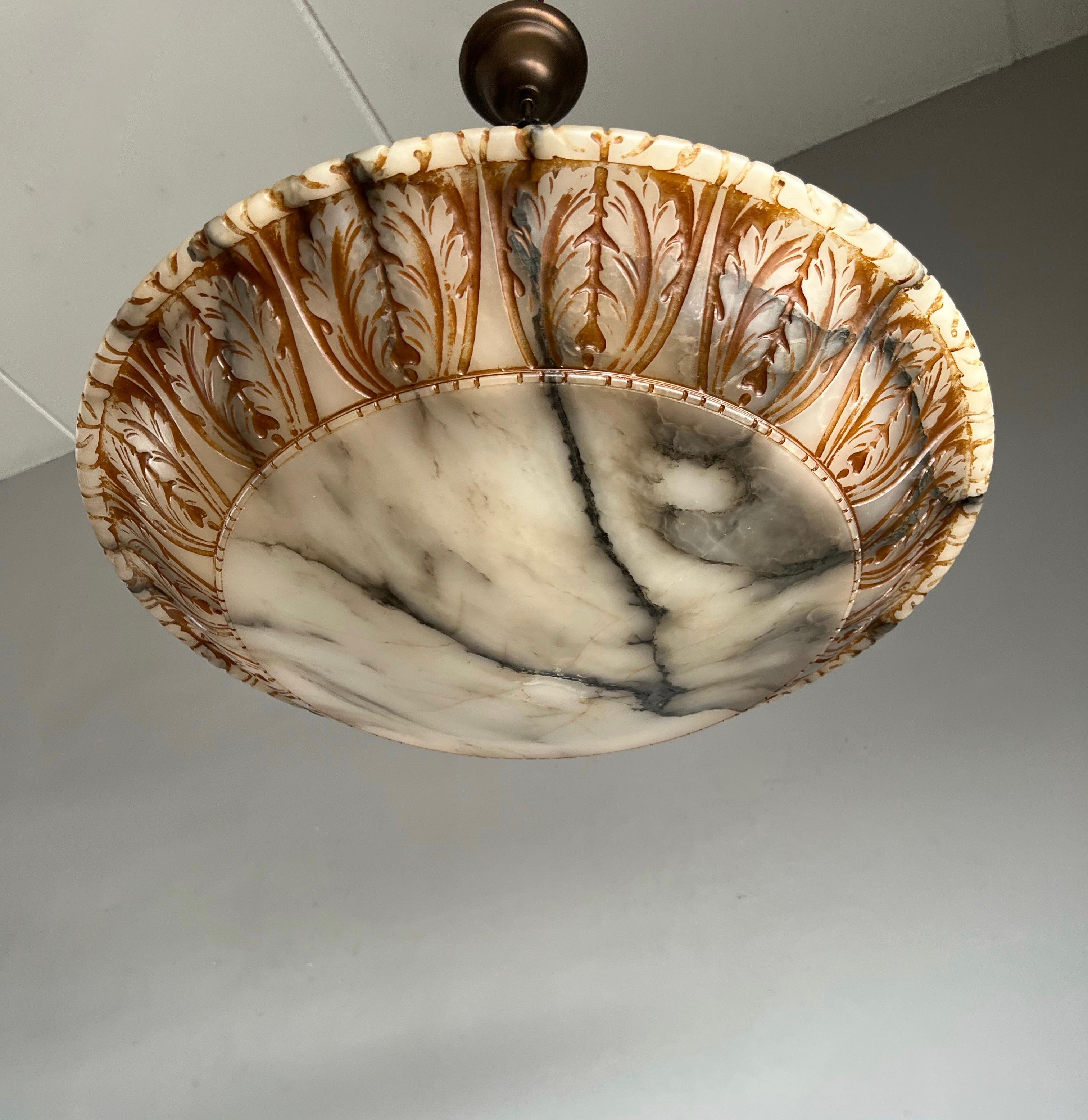 Remarkable size and unique design, hand carved, antique marble-like alabaster pendant light.

Thanks to its very large size & deep shade this remarkable alabaster chandelier is another one of our recent great finds that will light up both your days