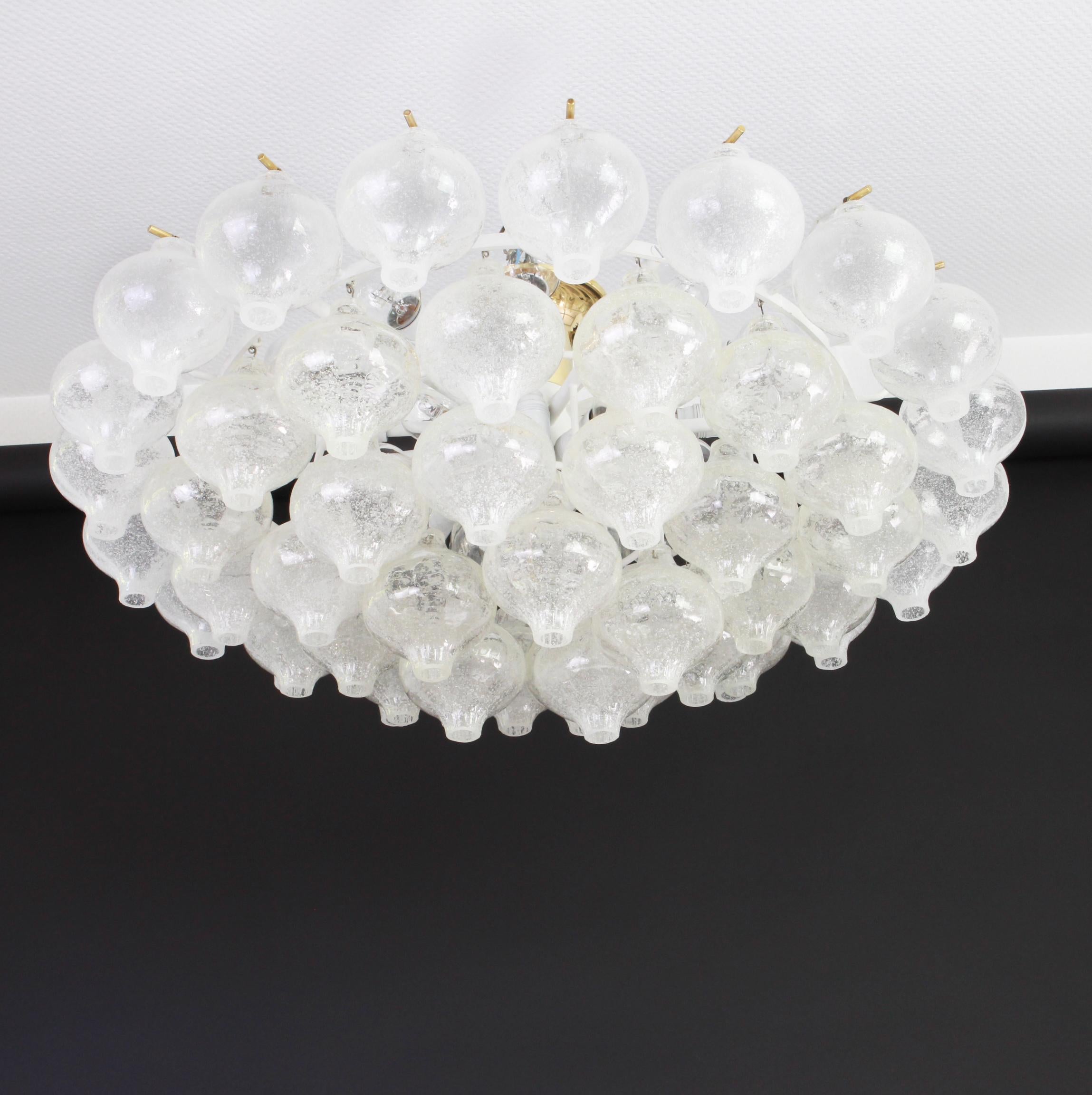 Wonderful onion shaped -Tulipan glass chandelier. 51 hand blown glasses suspended on white painted metal frame.
Best of design from the 1960s by Kalmar, Austria. High quality of the materials.

Sockets: The chandelier takes 21 small screw base