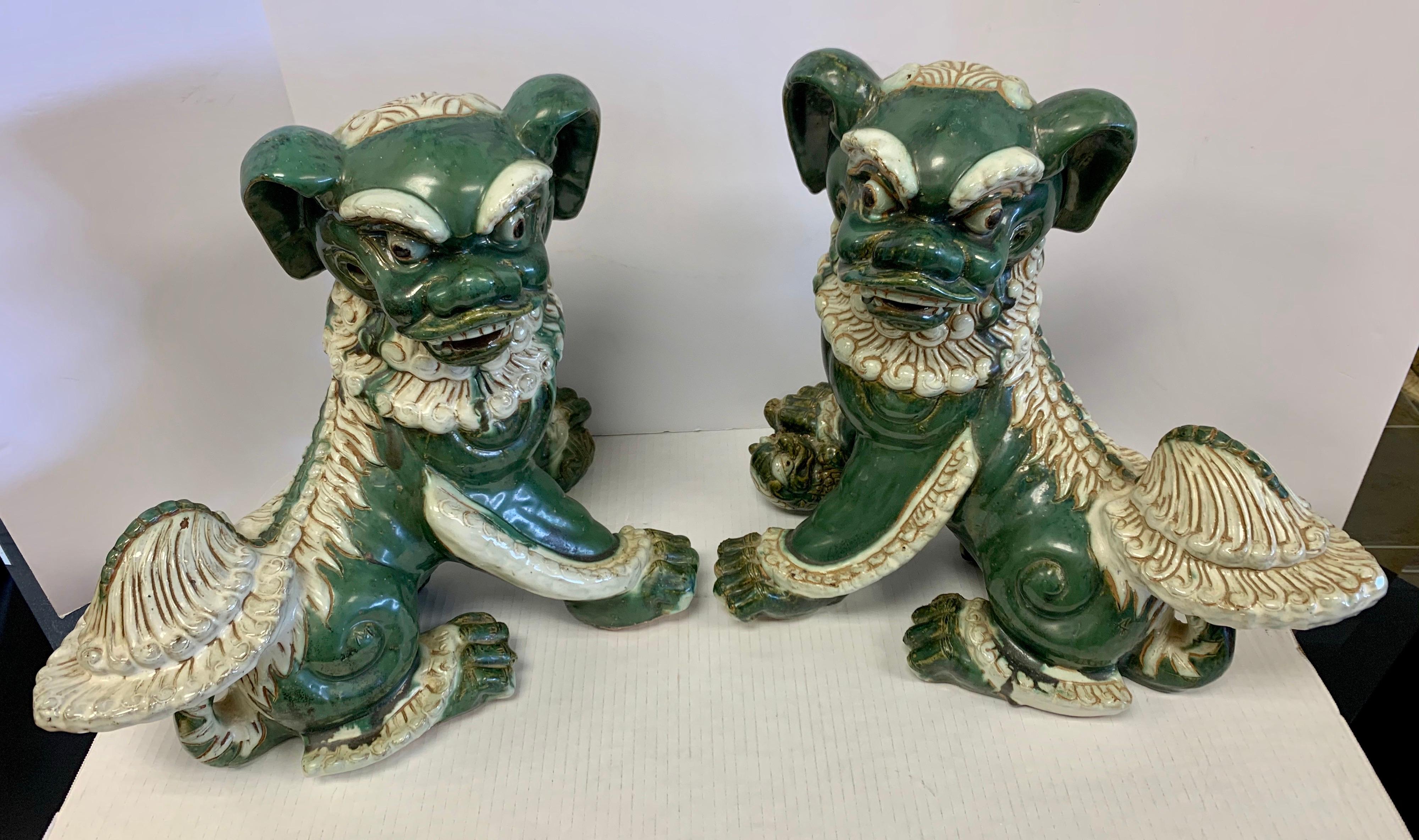 Magnificent pair of fine glazed porcelain Foo dogs from a Central Park West home. As admirers of Foo Dogs know, they were used to guard the entryway to temples and homes of the very rich, as such, they were guardian lions of the Far East. Paired