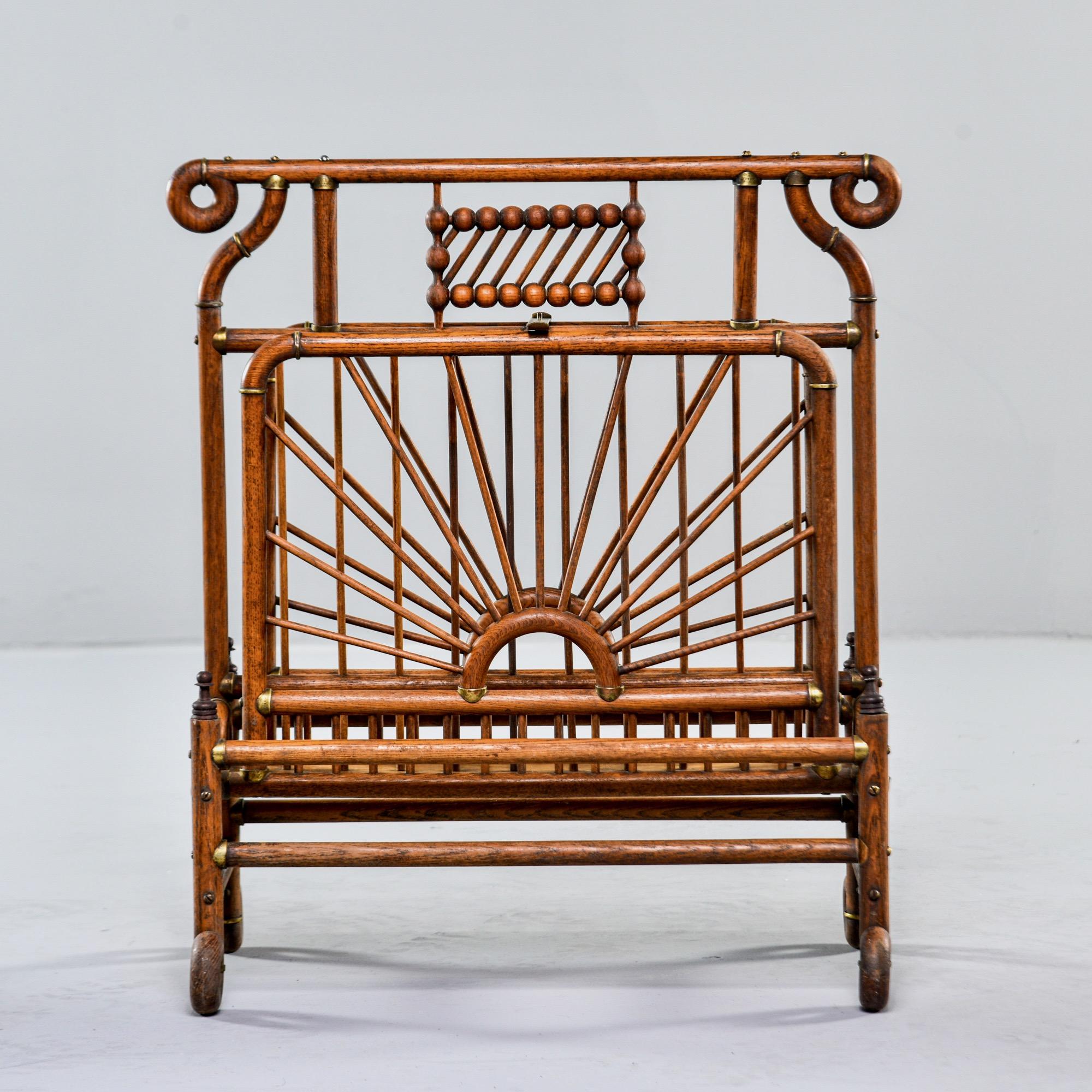 Late 19th century large bentwood and brass magazine rack. Two sections divided by tall center panel. Lots of decorative details - one of the brass fittings is stamped with Patent Feb 16 1892. Unknown maker. Found in the US.
