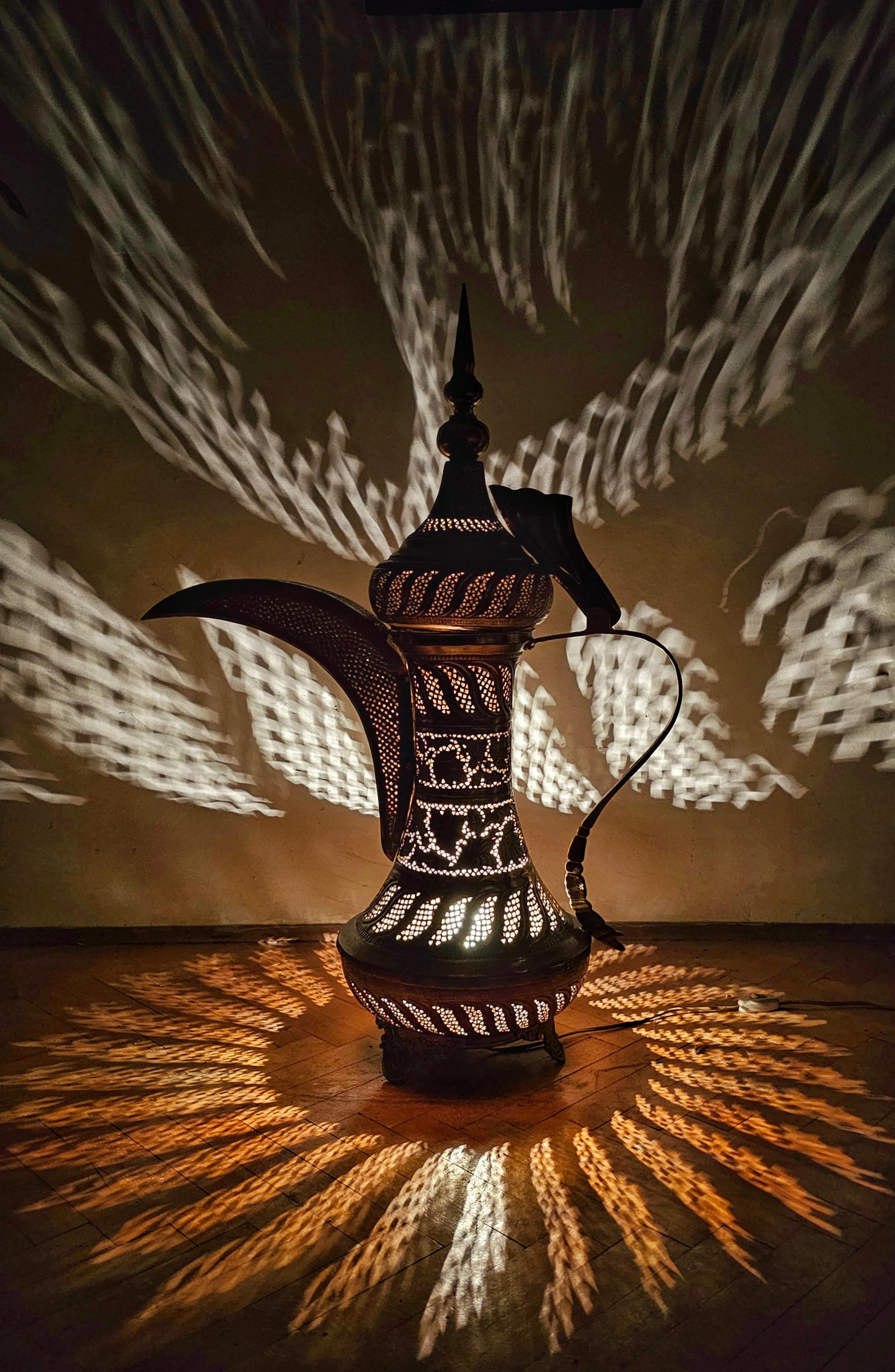 In this listing you will find a gorgeous vintage Arabian floor lamp done in pierced brass. It features a traditional shape of Arabian lamps and teapots, with a single light bulb inside of it. The piercing of the lamp is done by hand and in a
