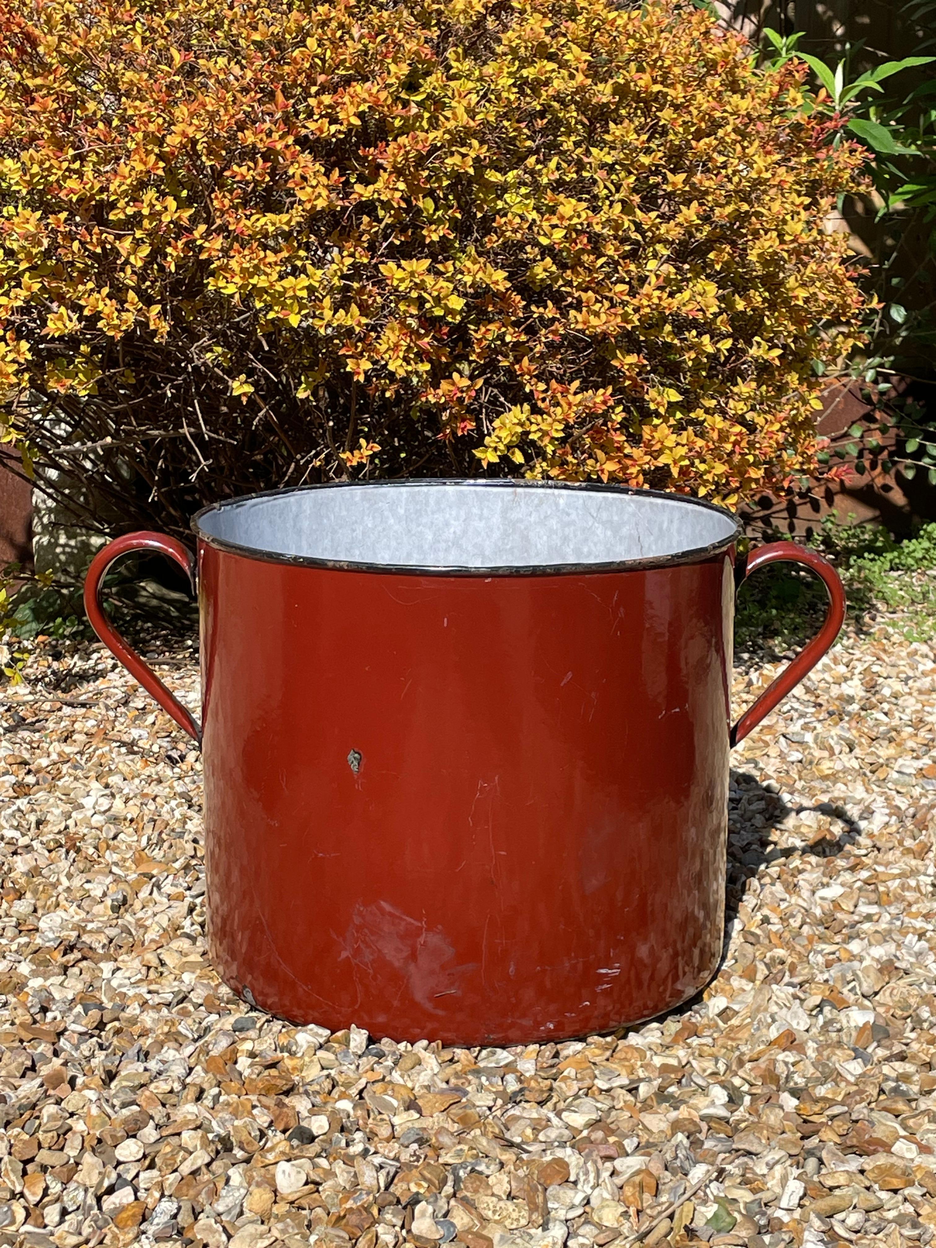 Extra large industrial oxide red enamelled planter. 

A beautiful large vintage piece with loads of character and patina. Large looped handles at the sides. This look beautiful planted with large shrubs or trees both inside and out.

We have three