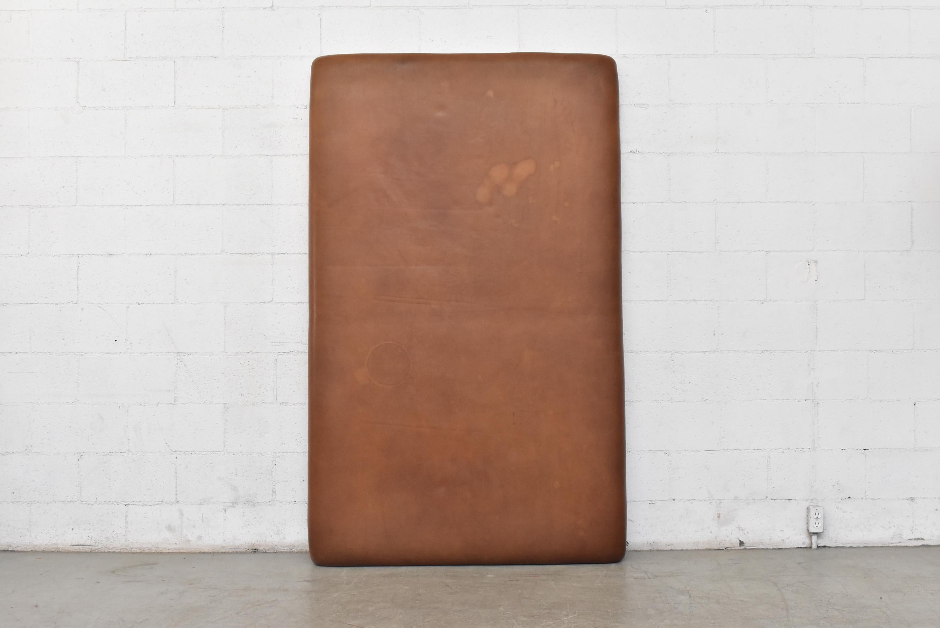 Extra-large natural leather gym mat with heavy wooden frame. Perfect for a king sized headboard. In original condition with visible wear, some staining and nice patina. Well loved.