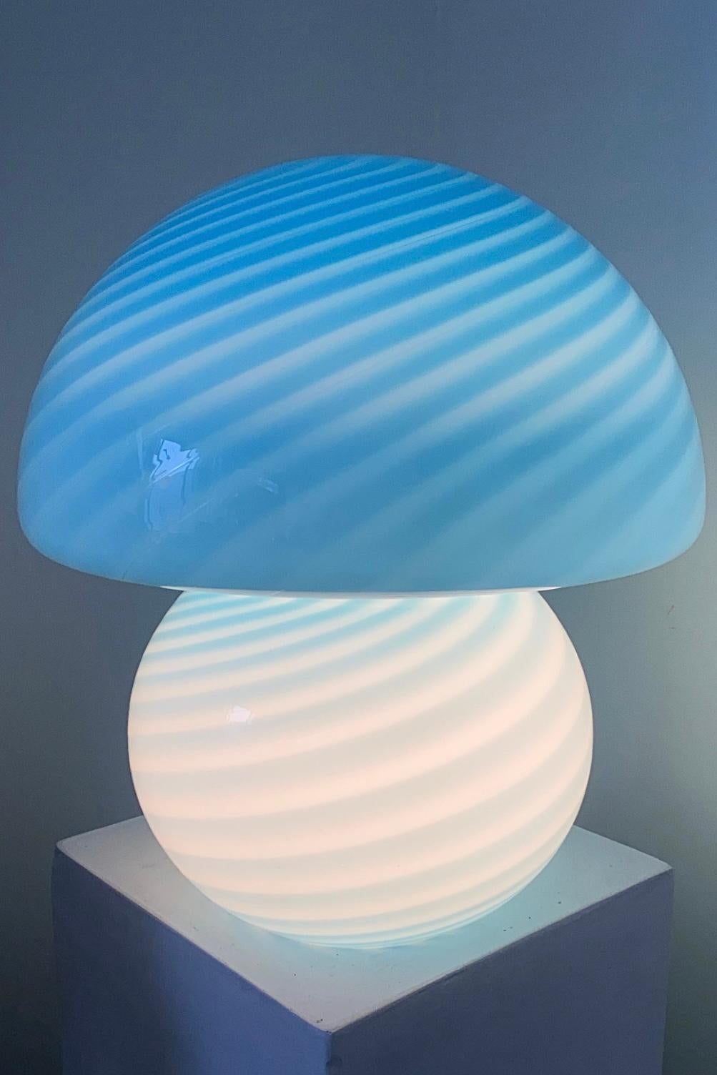 Large vintage Murano mushroom table lamp in a delicate blue shade. Mouth blown in a single piece of glass in a rare shape with a swirl pattern. Handmade in Italy, 1960s-1970s. The lamp has an original Murano label.
H: 37 cm D: 32 cm?