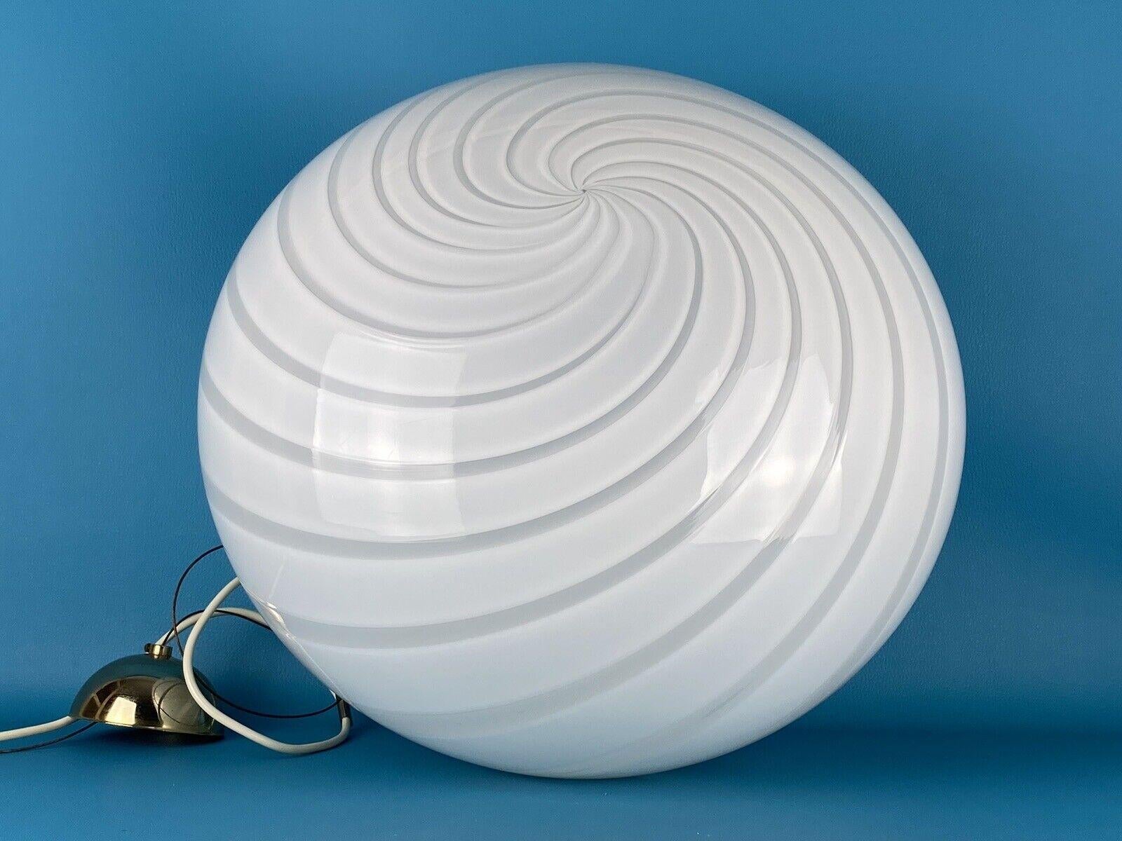 Extra large vintage Murano pendant ceiling lamp in white opaline glass. The glass is hand-blown in an oval shape with a beautiful white swirl pattern. Brass color suspension. Handmade in Italy, 1970s.
D: 45 cm H: 35 cm (glass)


